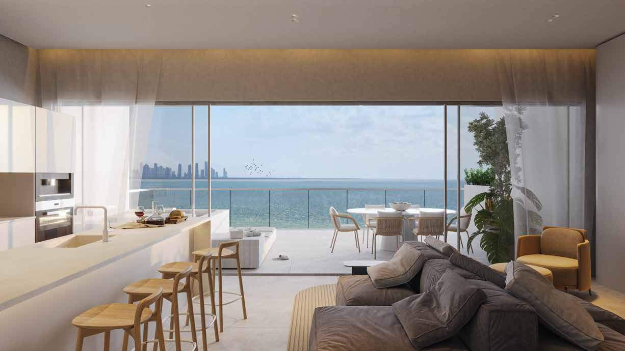 Living room and kitchen of an O Club Residences apartment with a view of the bay