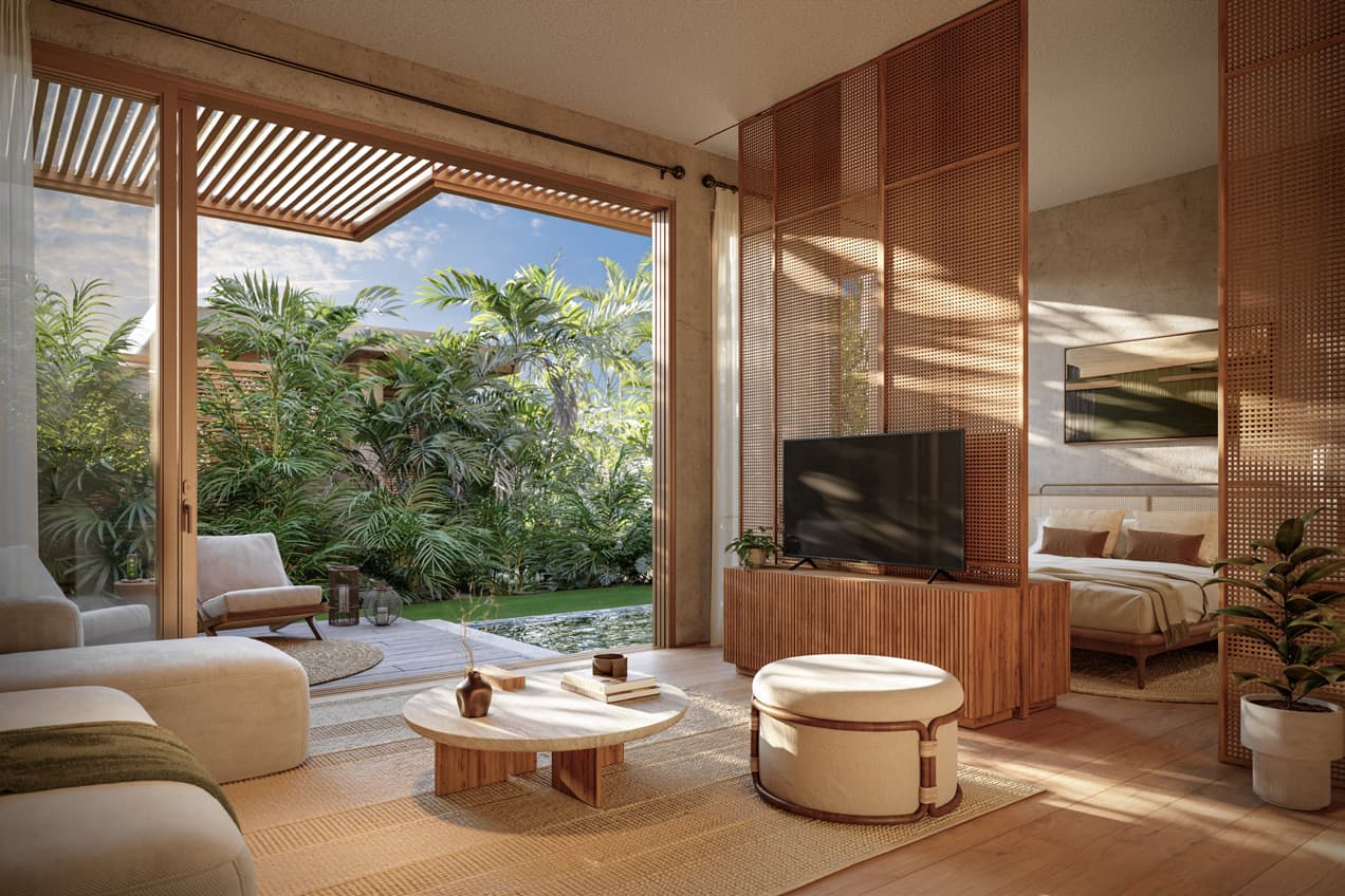 Living area and bedroom opening to the garden at Seashore Beachfront Villas