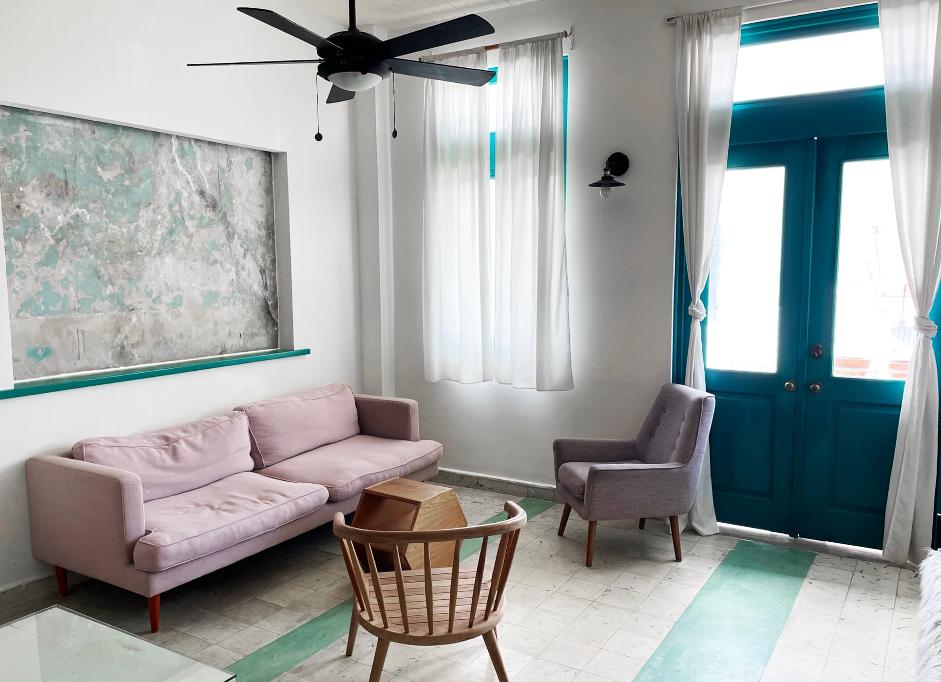 Living room of apartment 811 at Casa 8-23 with sofa and double doors to the balcony