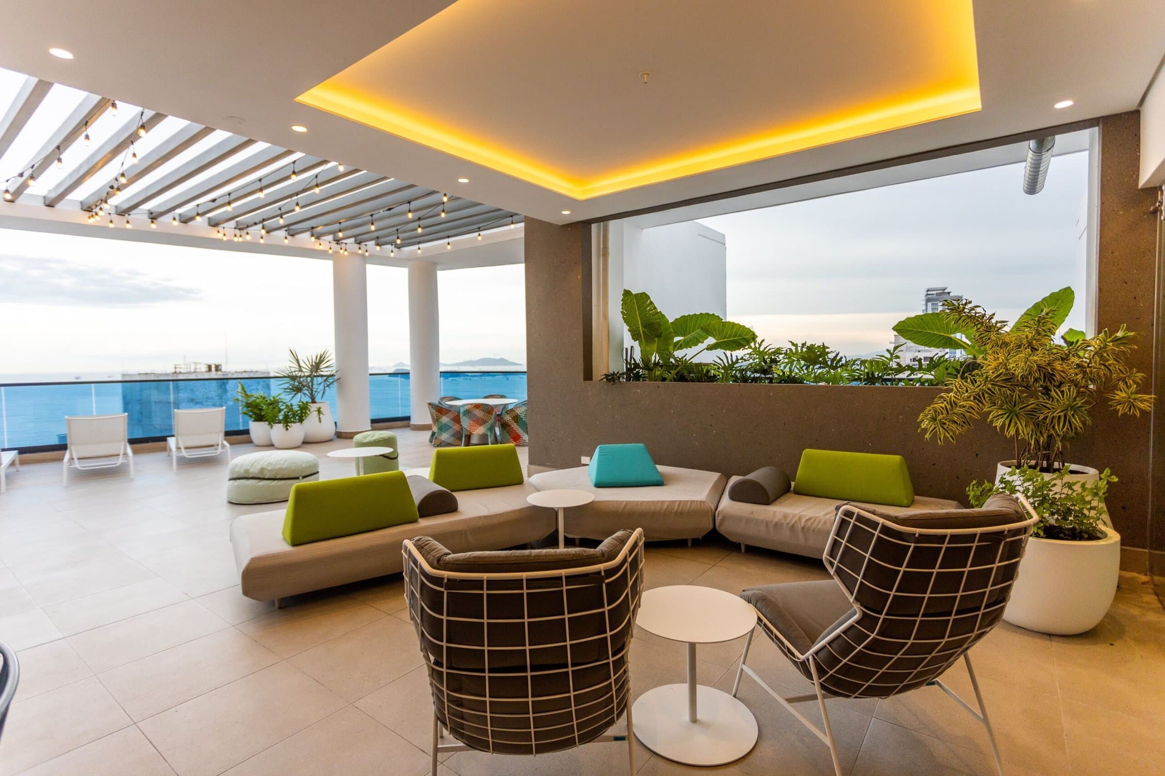 Ocean Front rooftop lounge terrace with sofas overlooking the bay