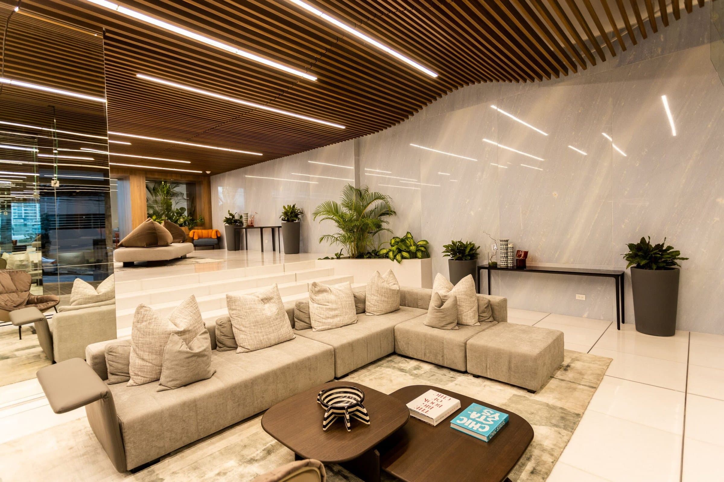 Ocean Front social lounge with sofas and wood-slat ceiling