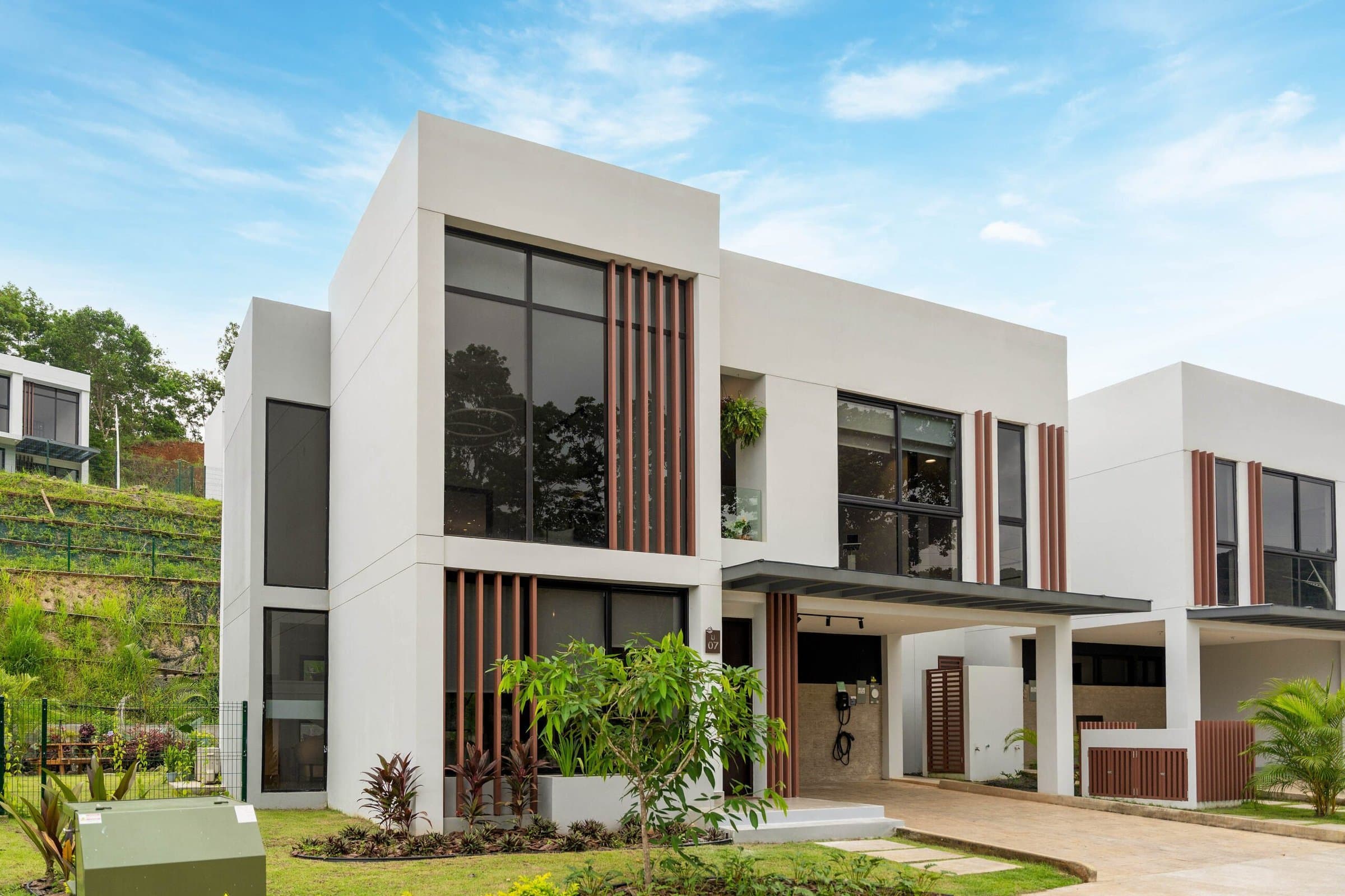 Riverwalk Villas house facade with wood-slat accents and carport