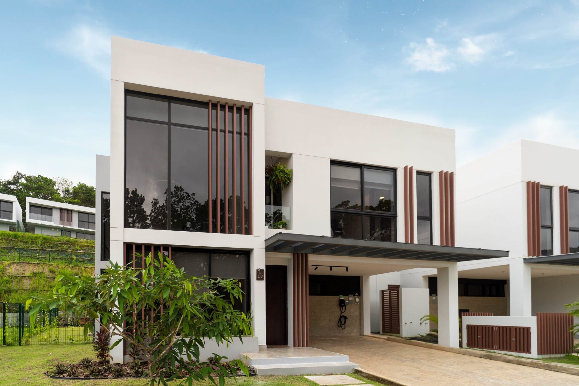 Riverwalk Villas modern house front with covered carport and garden
