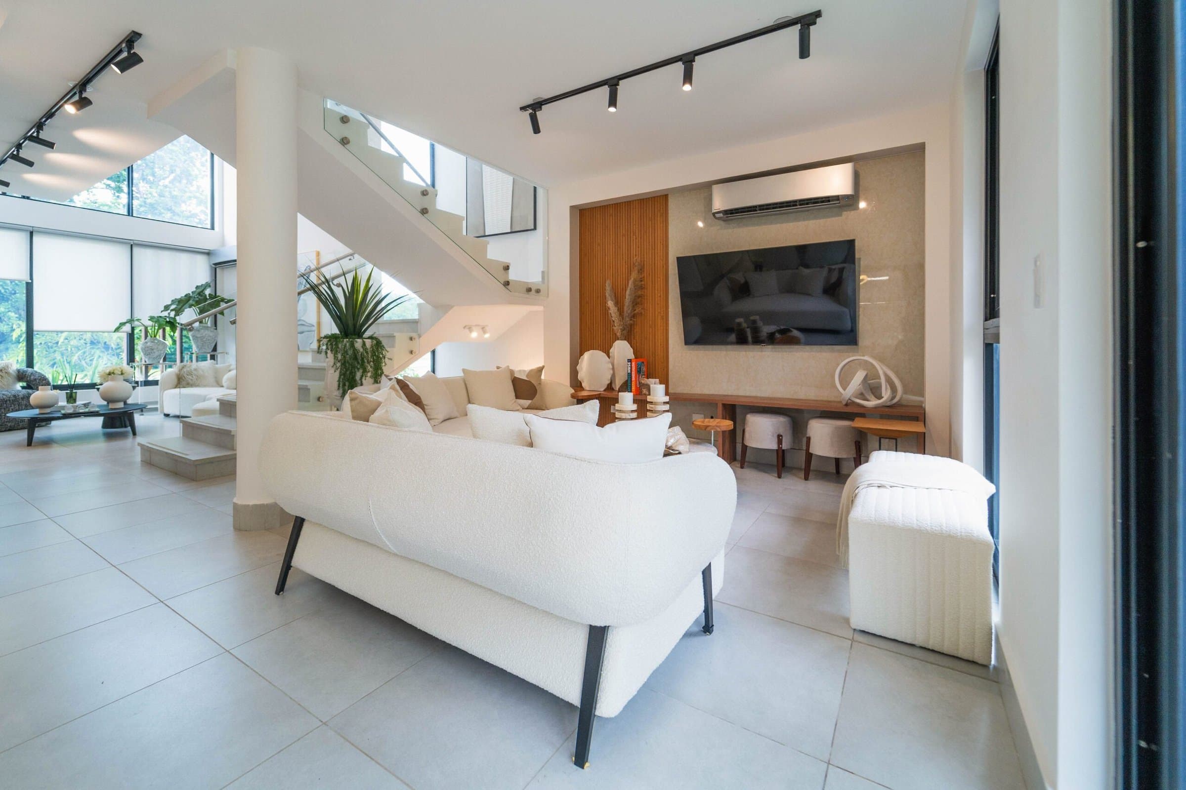 Riverwalk Villas double-height living room with staircase