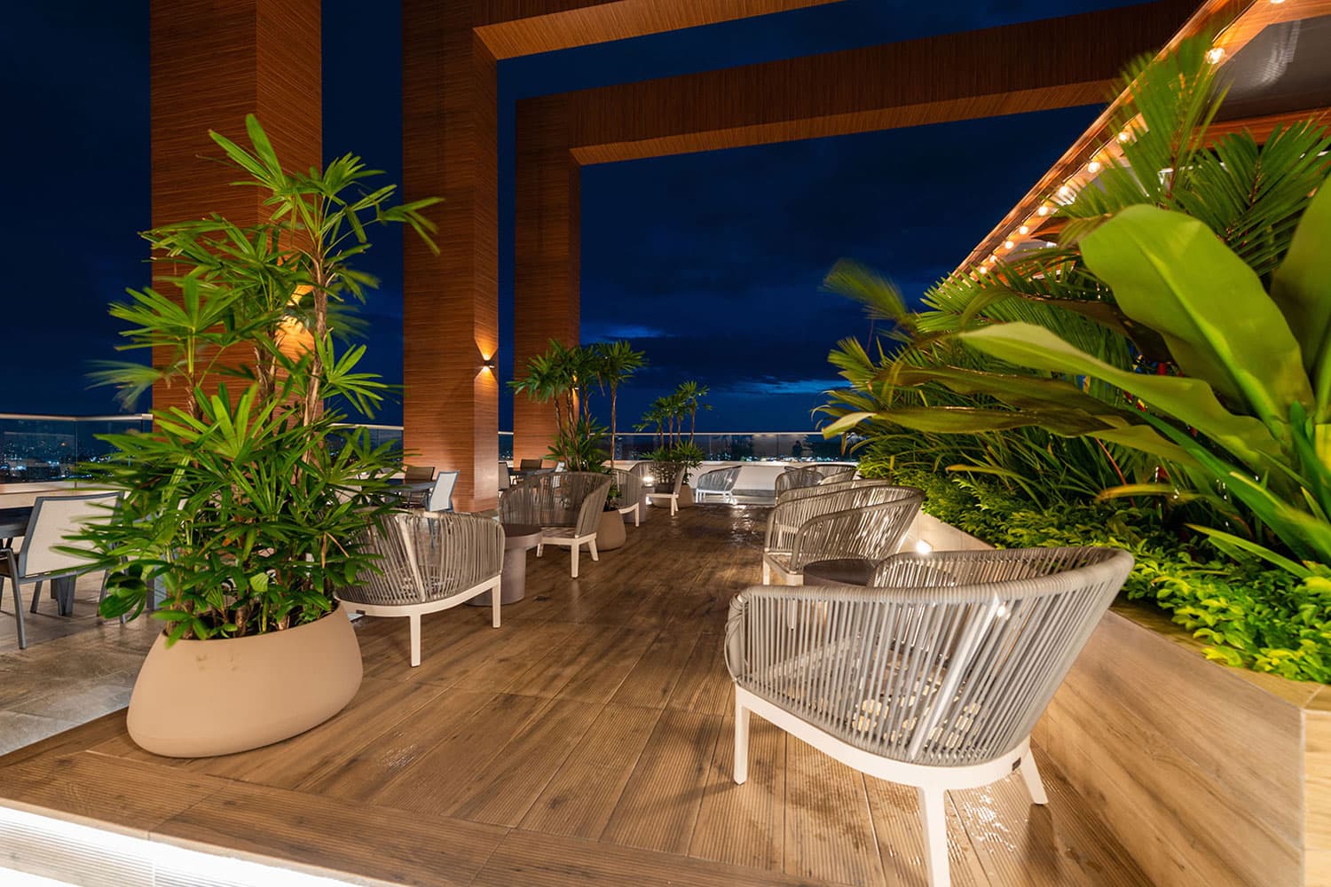 Greenwood Towers sky lounge terrace with plants and seating