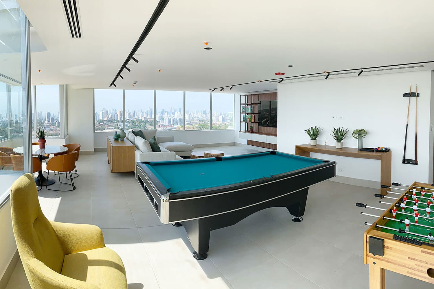 Greenwood Towers game room with pool table and city views