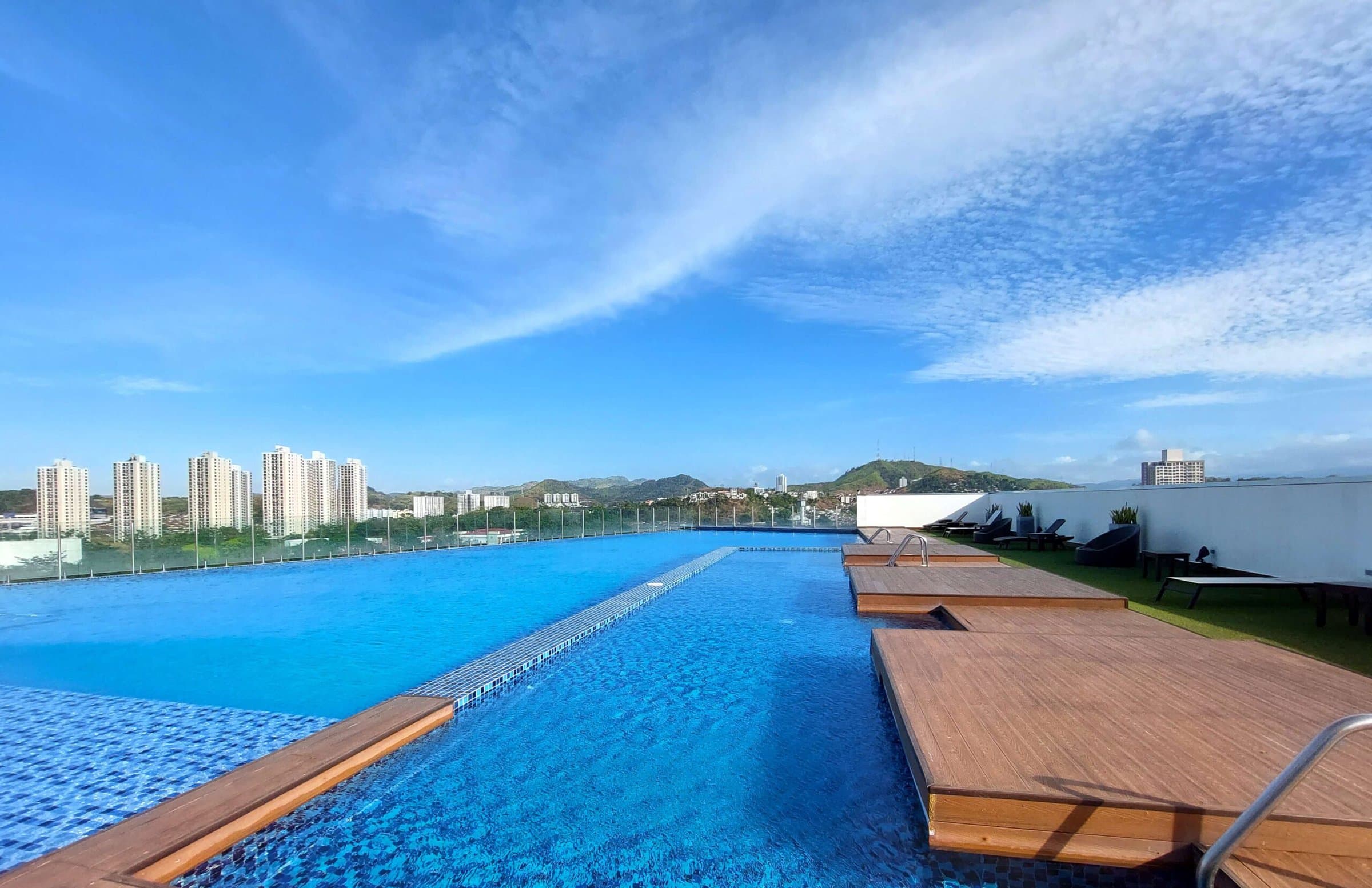 Sky Point rooftop infinity pool with wood deck and city views