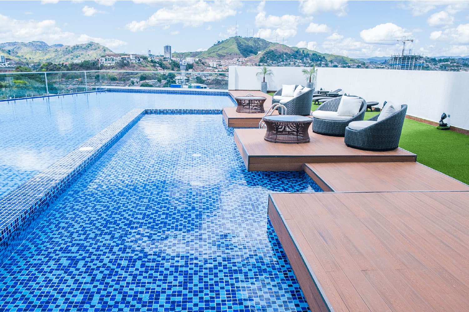 Sky Point pool with loungers overlooking the hills of Panama City