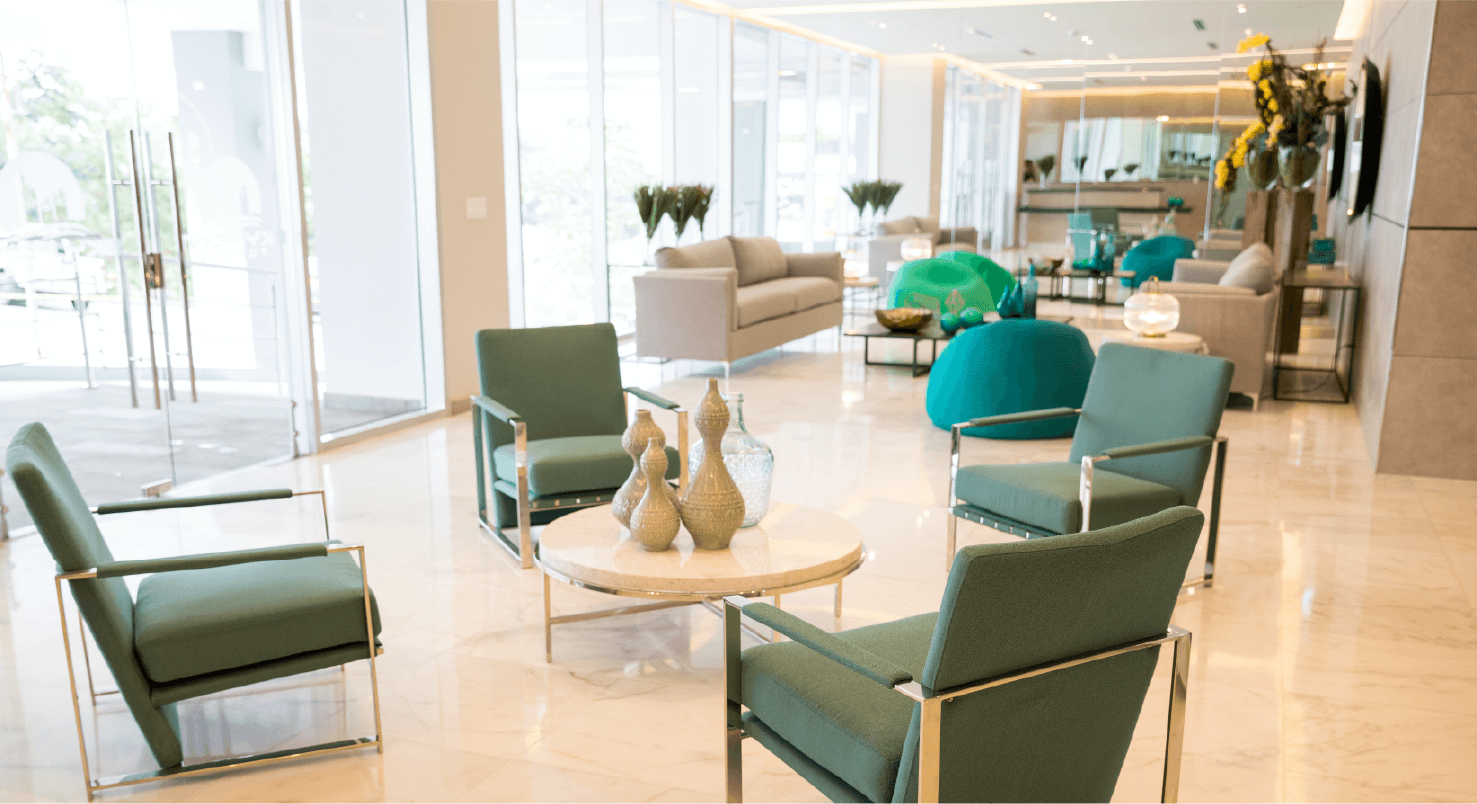 Sky Point lobby seating area with green armchairs