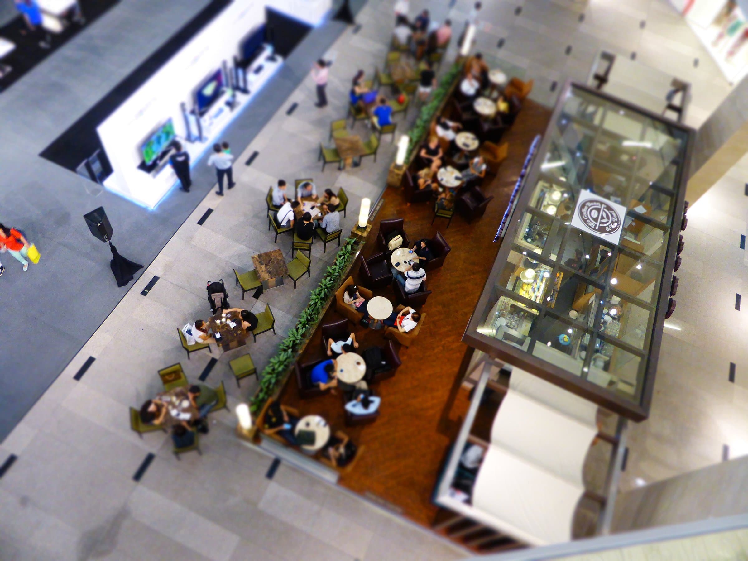 Overhead view of a café and shops inside a shopping mall atrium