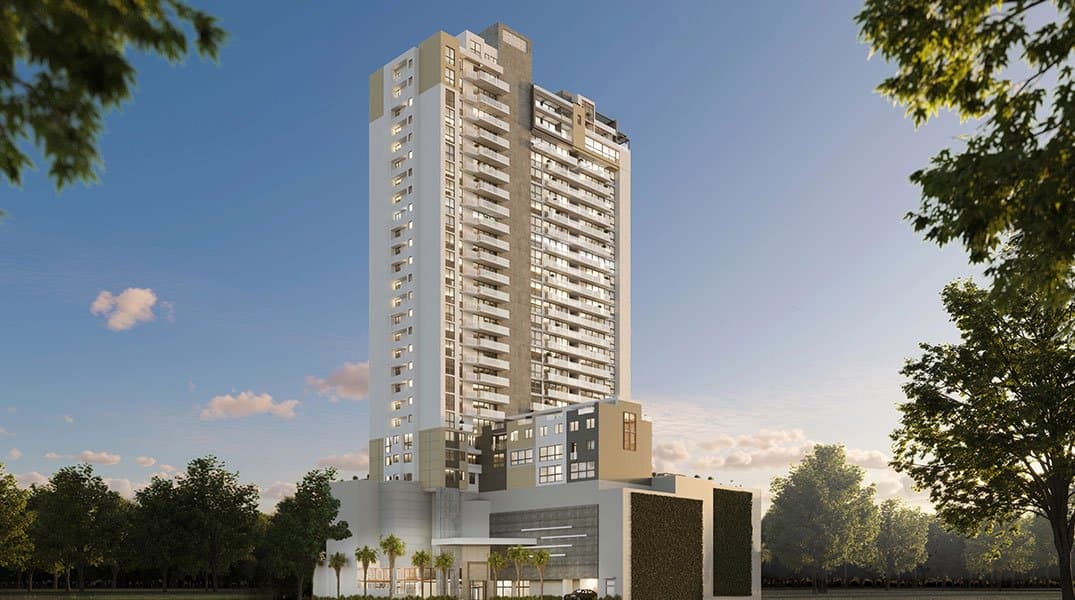 Oceana Residences & Skyhomes tower seen from street level among trees in Santa Maria