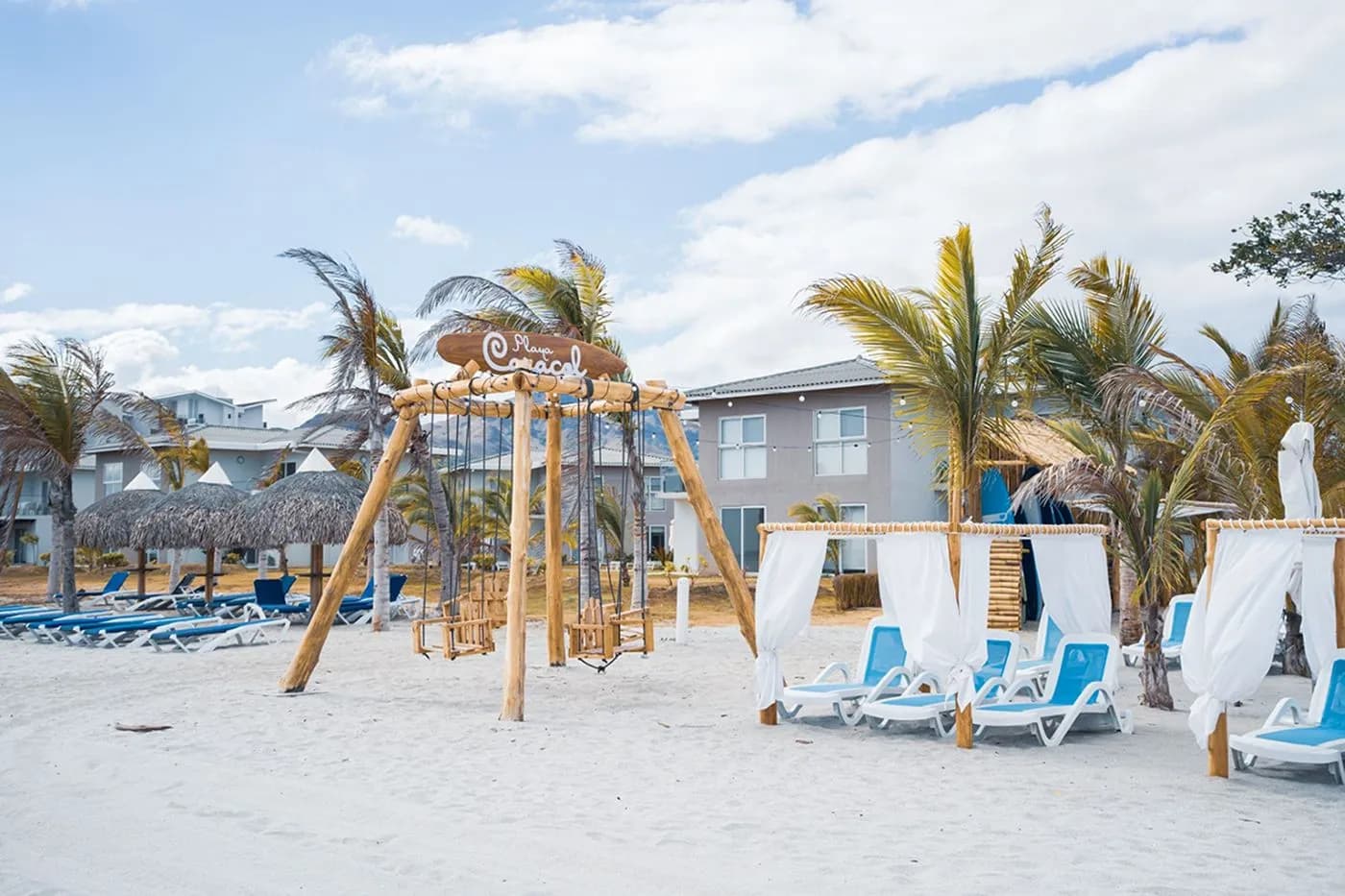 Beachfront cabanas and playground at The Tides beach club