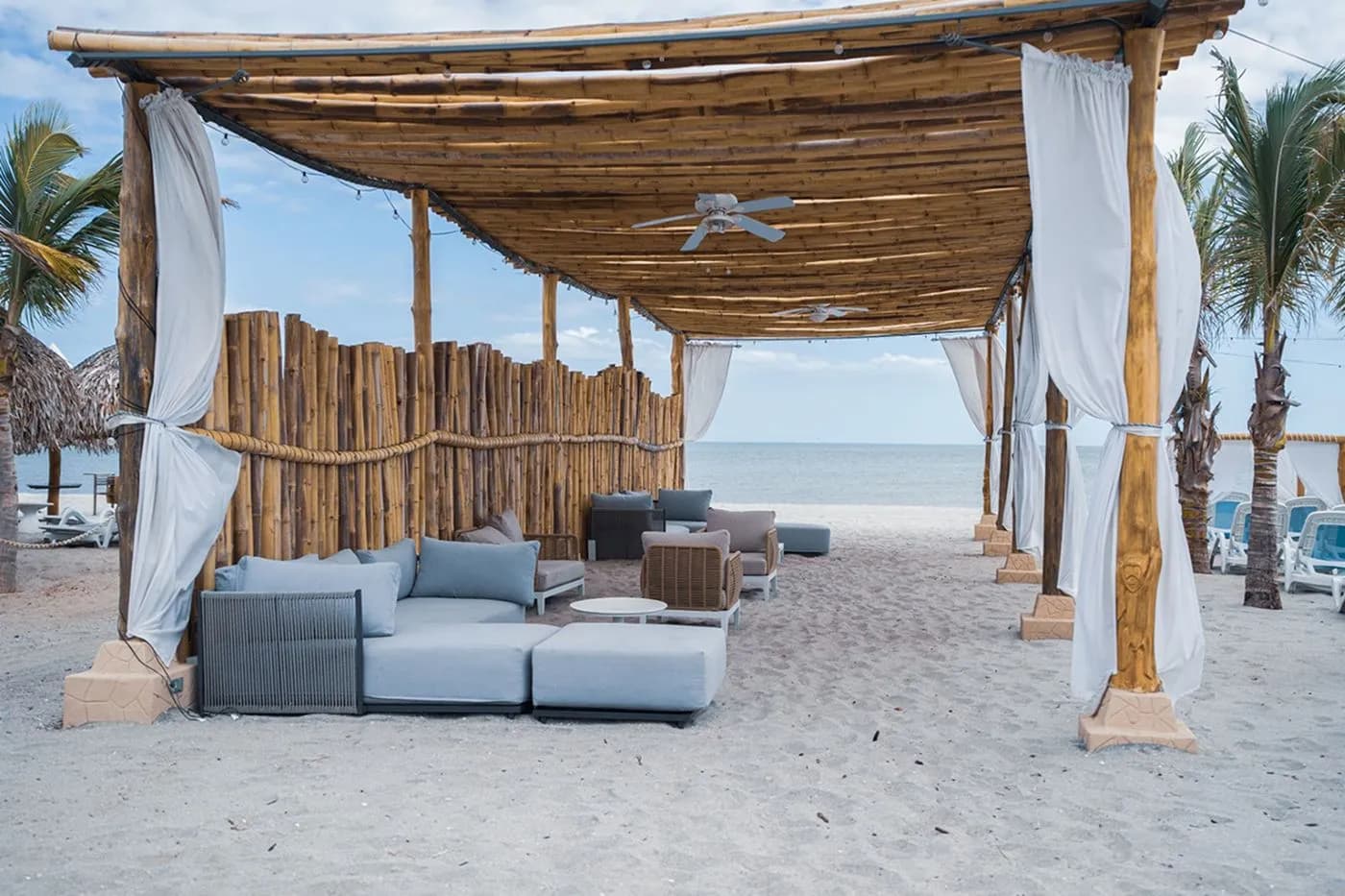 Shaded beach cabana lounge facing the ocean at The Tides