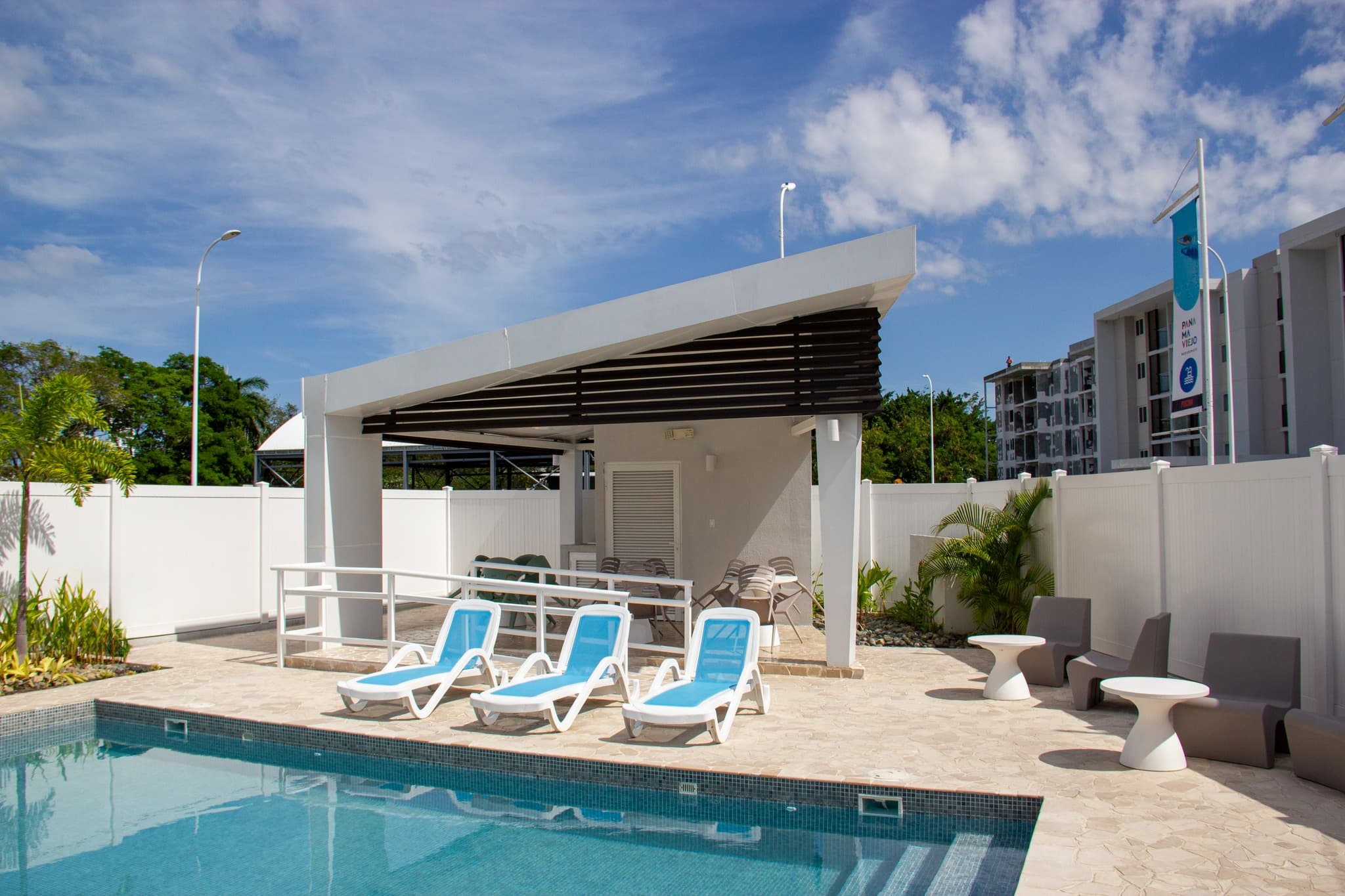 Pool deck and shaded lounge at Panama Viejo Residences