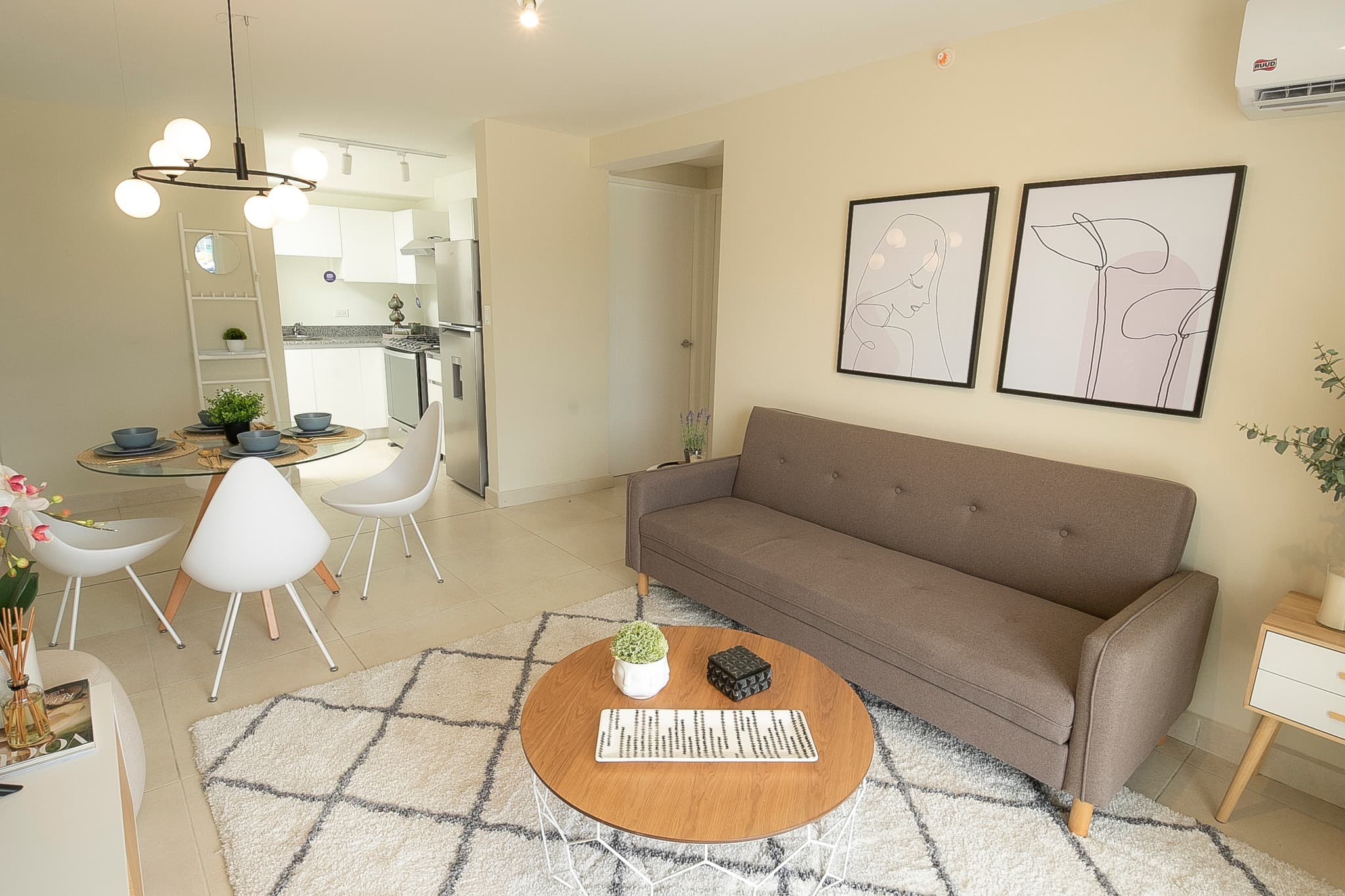Living room with sofa and dining area in a Panama Viejo Residences apartment