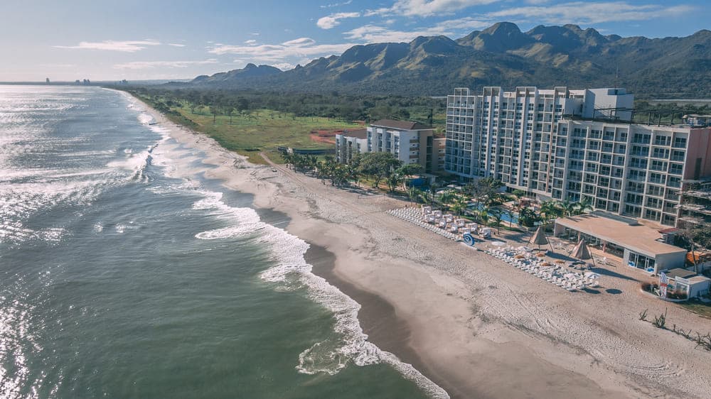 Aerial view of Surfside along the Playa Caracol shoreline with Cerro Chame behind