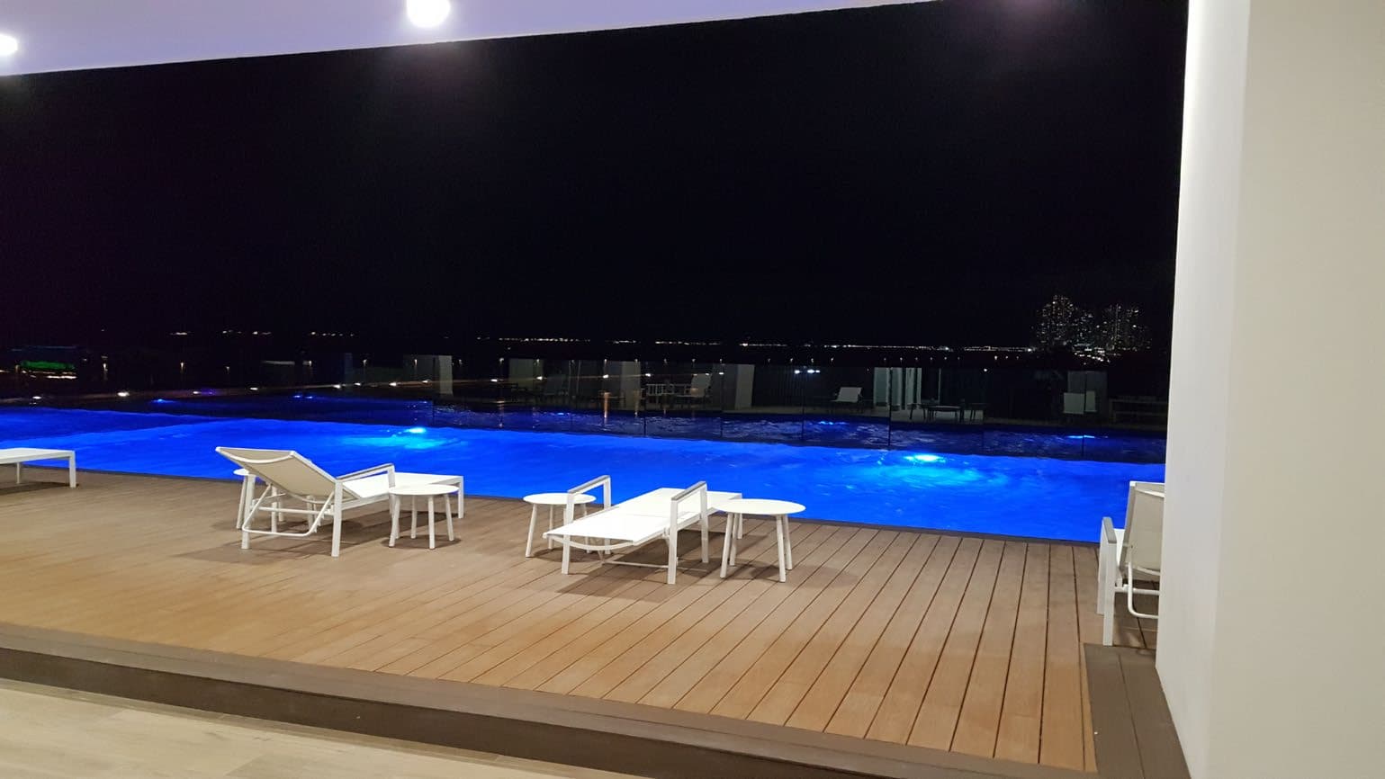 Bali pool deck at night with the illuminated infinity pool