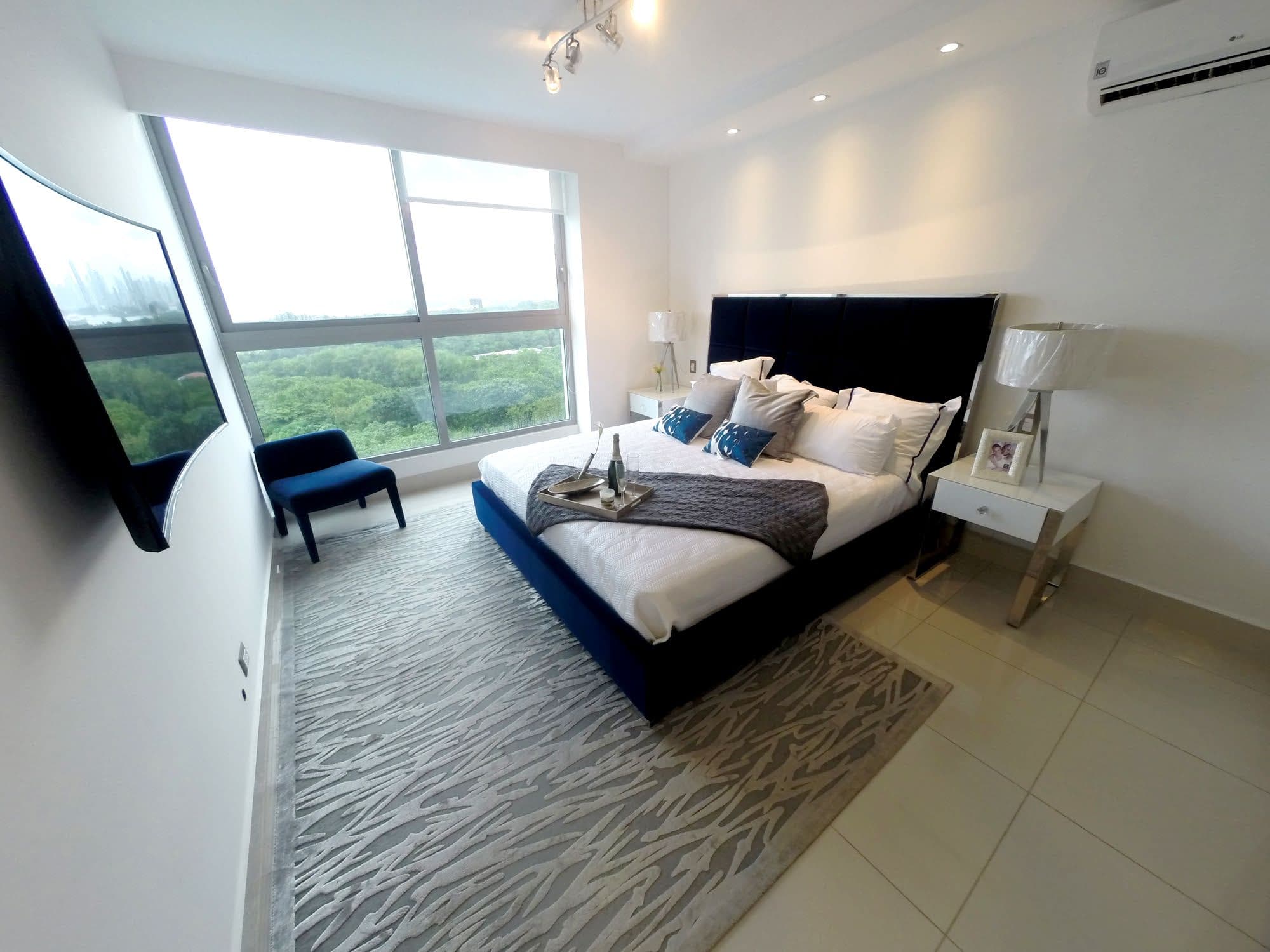 Bedroom at Bali with floor-to-ceiling windows and green views