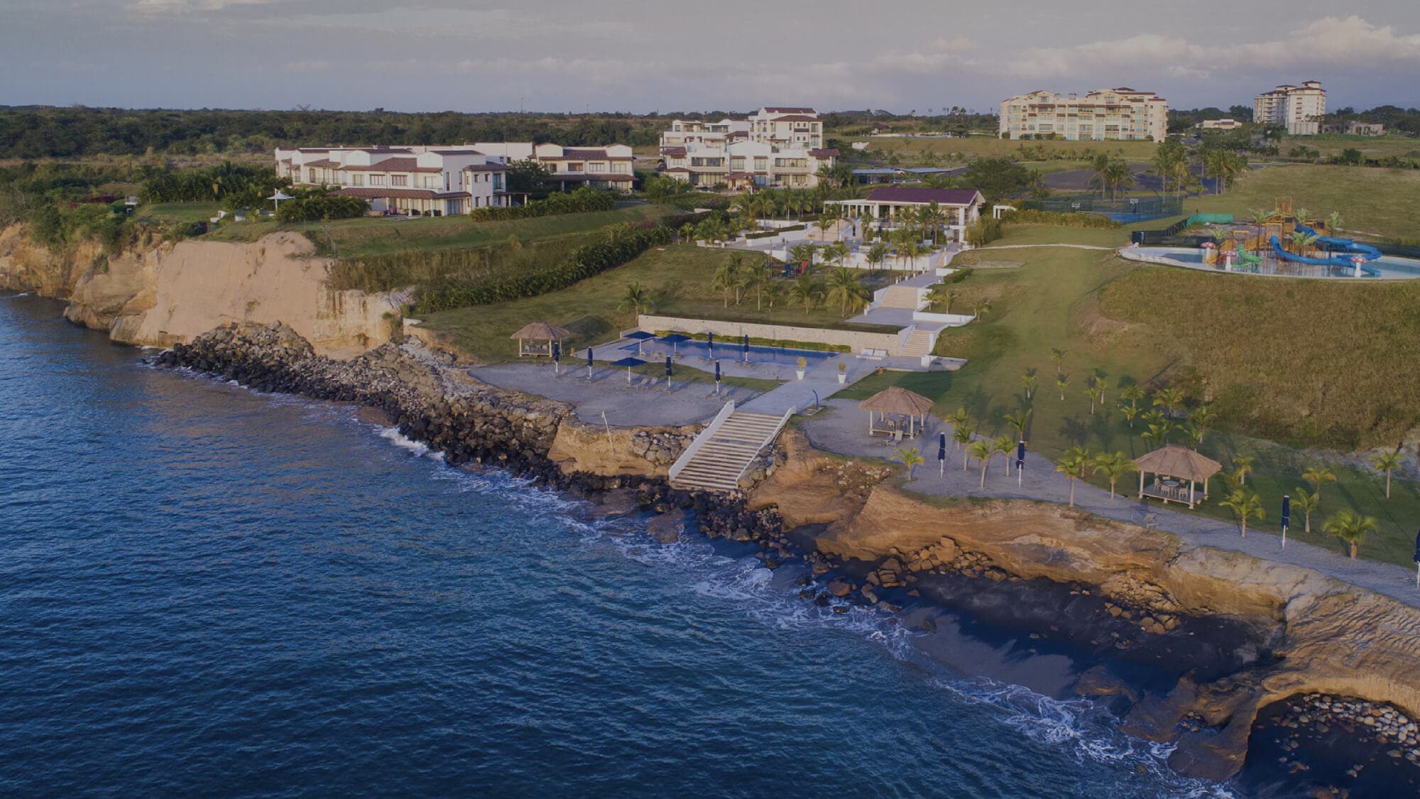 Aerial view of Casamar's oceanfront clifftop and residences at dusk