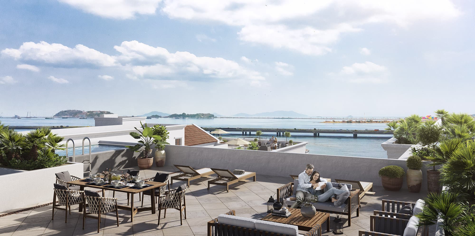 Rooftop terrace with lounge and dining furniture overlooking the Bay of Panama at Santa Familia