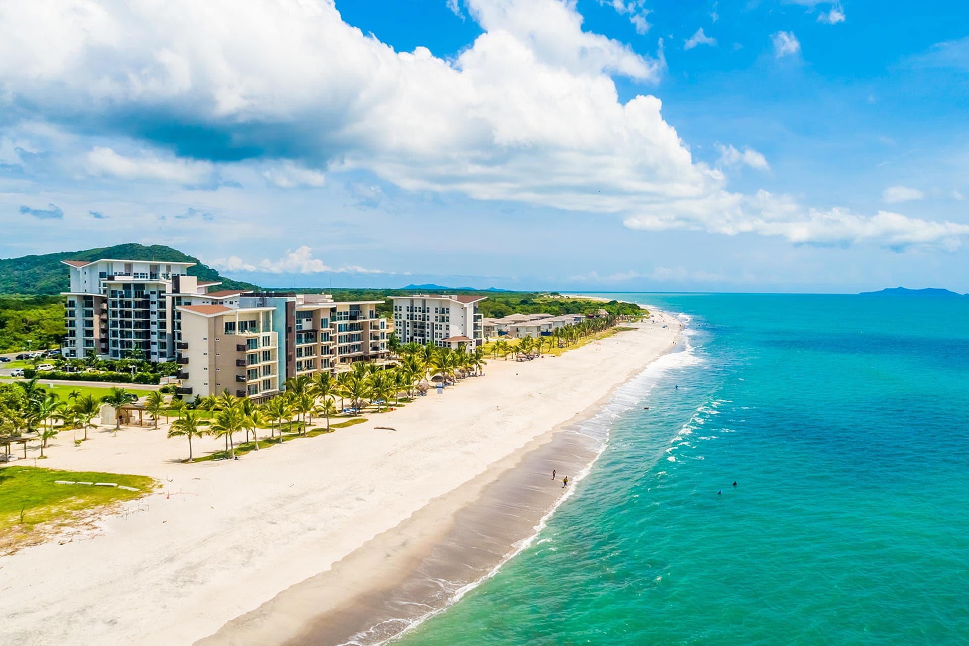 Aerial view of the Playa Caracol beachfront towers and white sand beach
