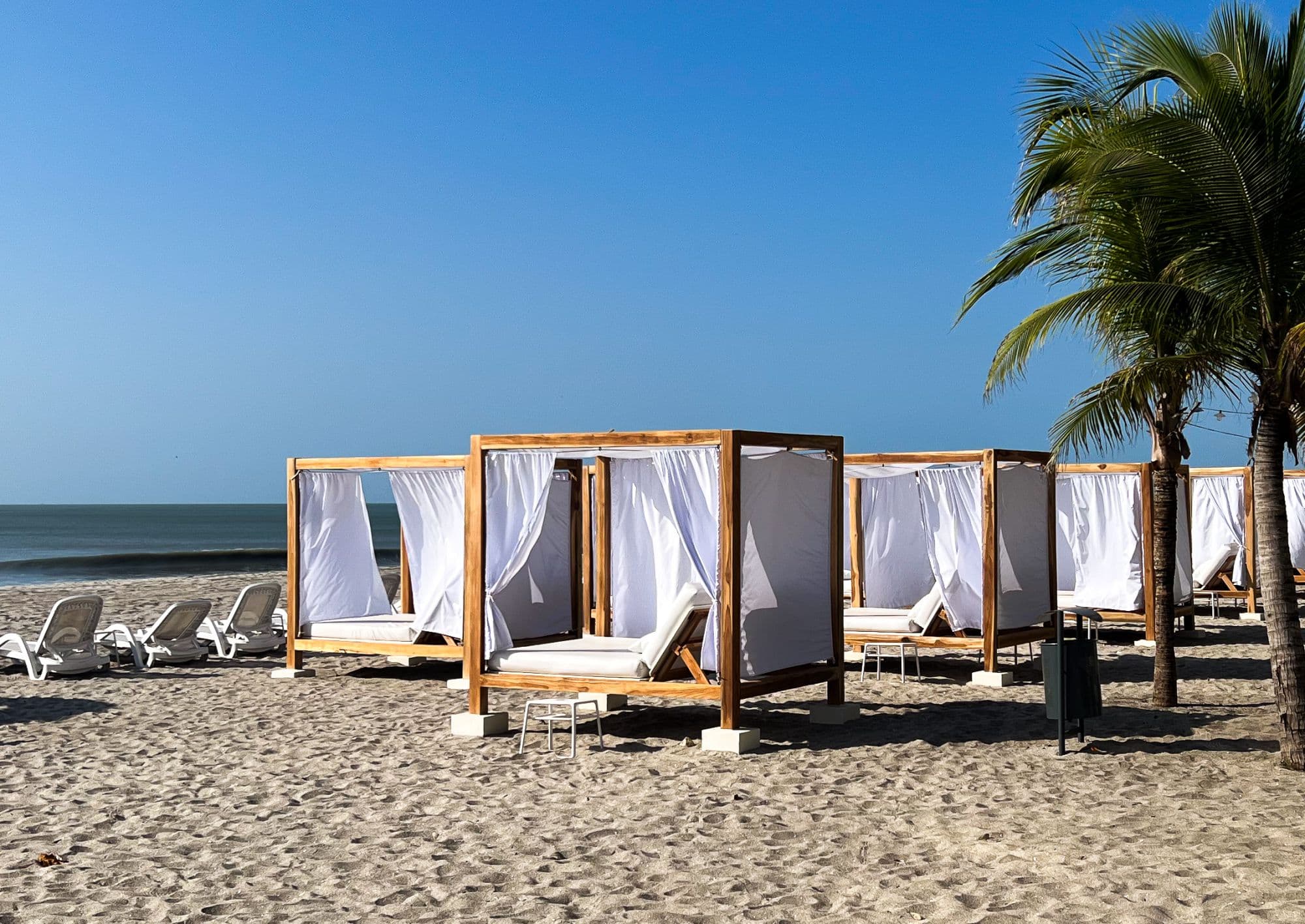 Beach cabanas on the sand at Playa Caracol