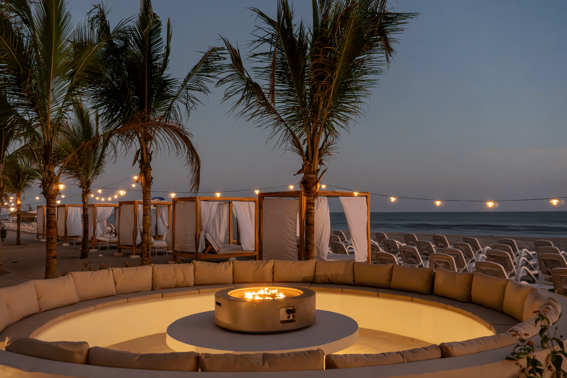 Fire pit lounge by the beach at Playa Caracol