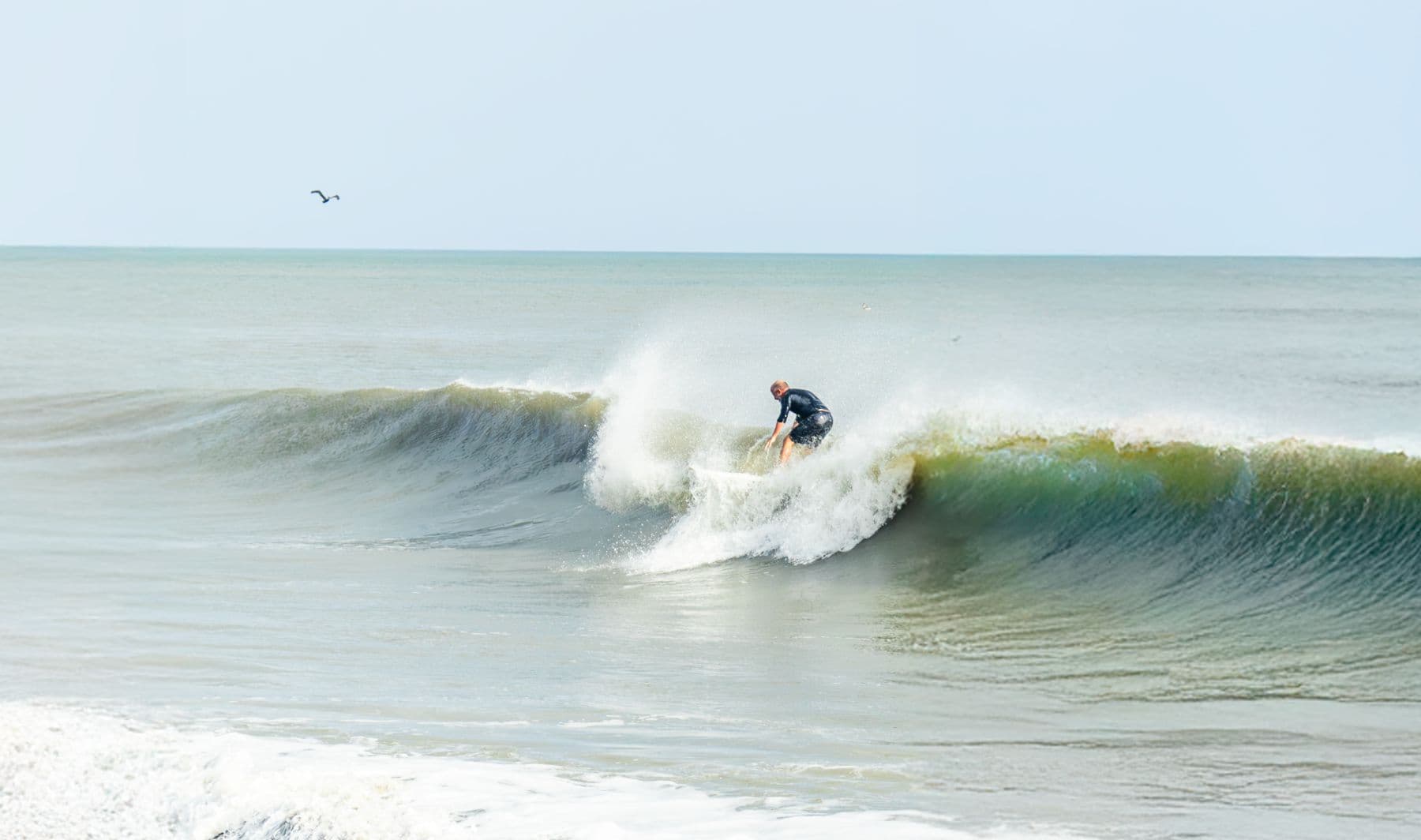Surfer riding a wave at Playa Caracol