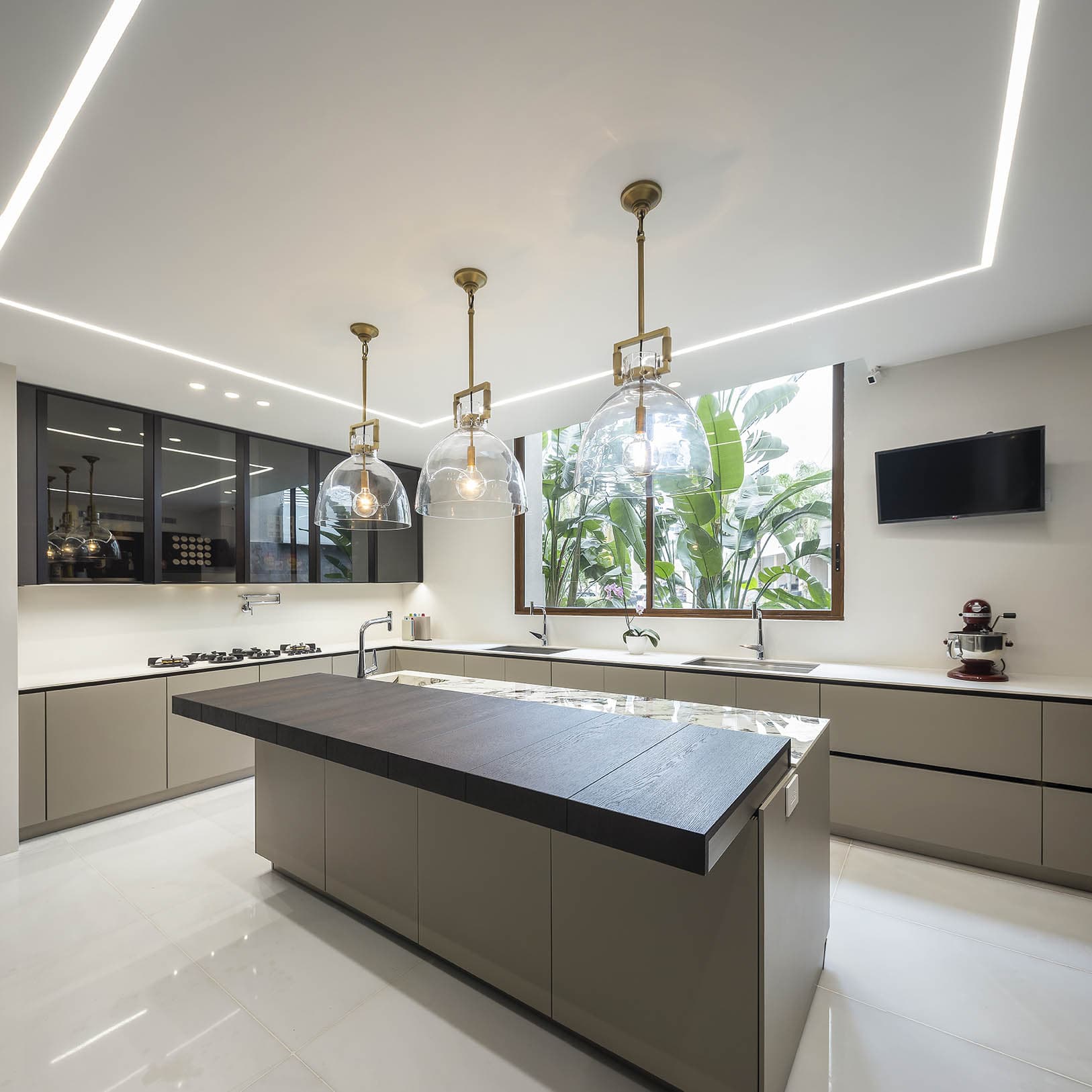 Kitchen with a dark island in an apartment at The Residences
