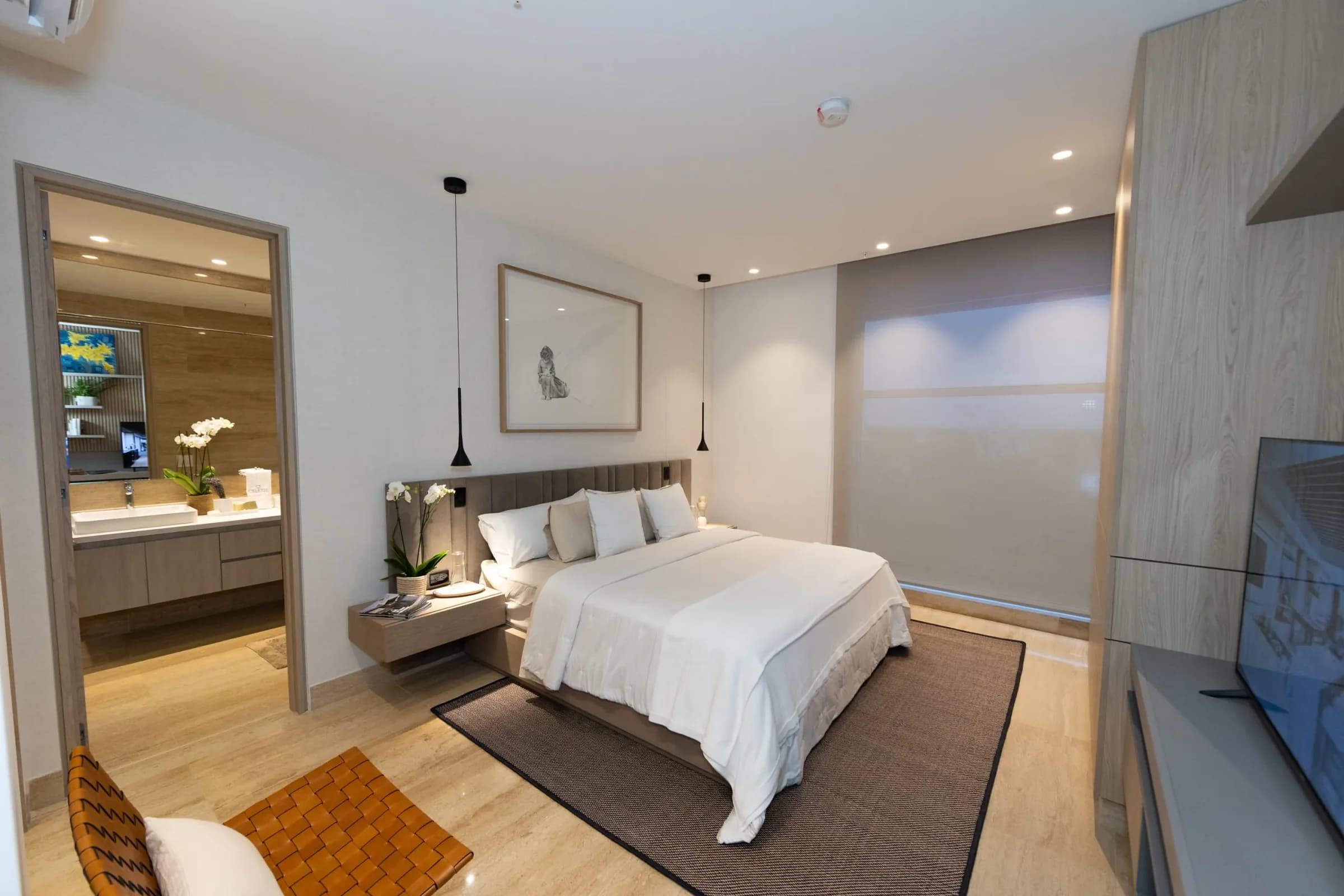 Primary bedroom with en-suite bathroom in the Celeste model apartment