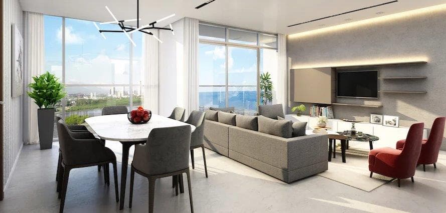 Living and dining room with city views in a Victory Sport apartment