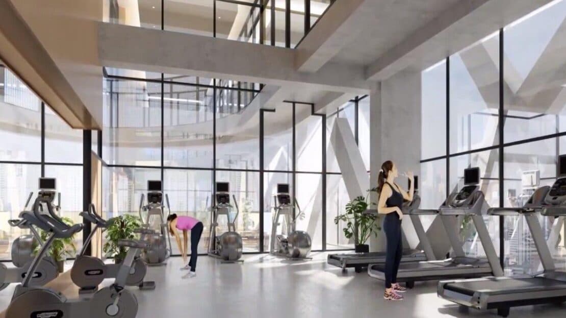 Gym with cardio machines and floor-to-ceiling windows at Victory Sport