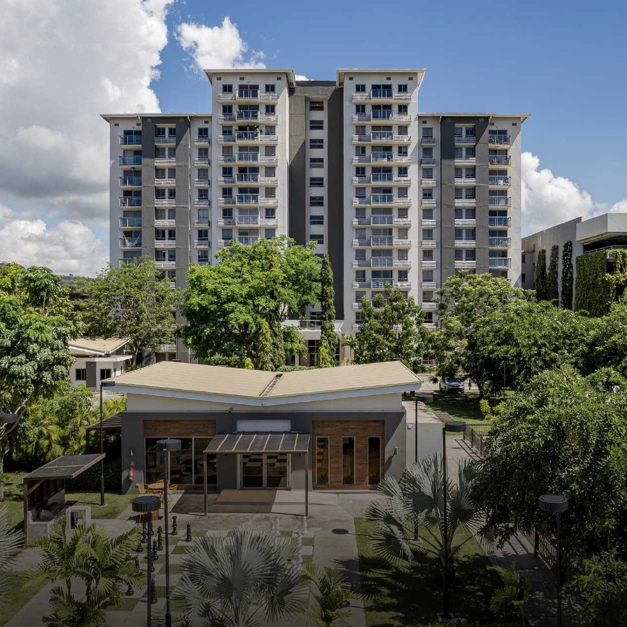 Parterre apartment tower rising above the tropical trees in Panama Pacifico