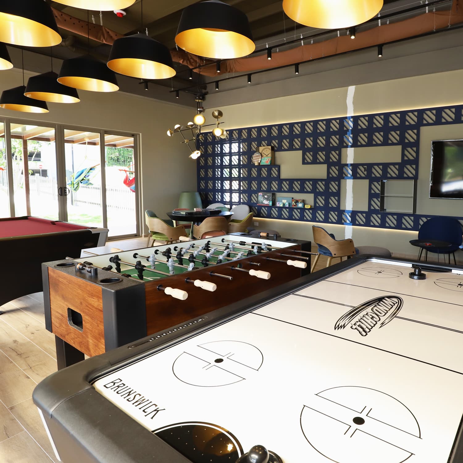 Game room with foosball and air hockey tables at Parterre