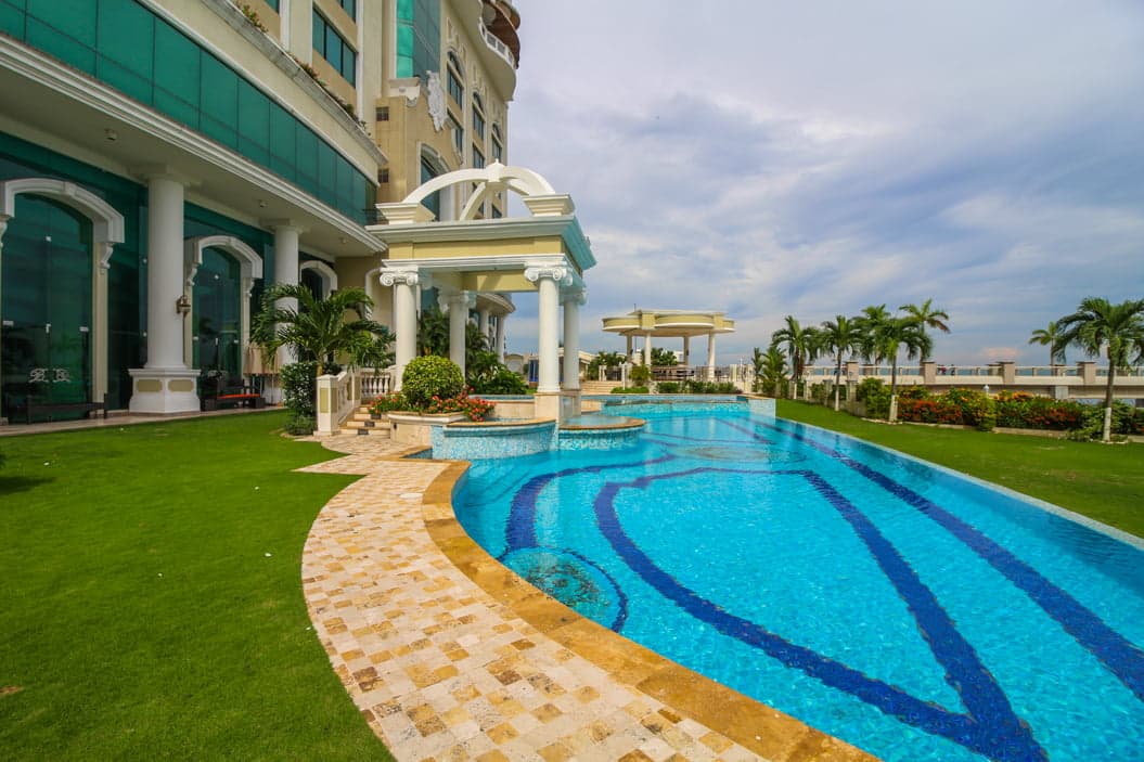 Bellagio pool deck with mosaic pool, lawn and gazebo facing the bay