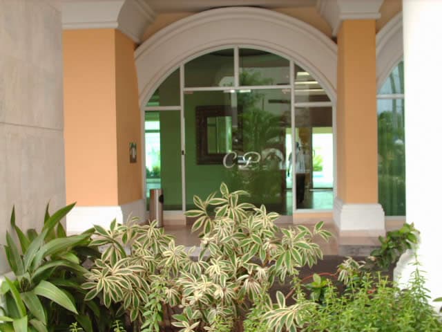 Arched glass lobby entrance of a Costa Pacifica tower