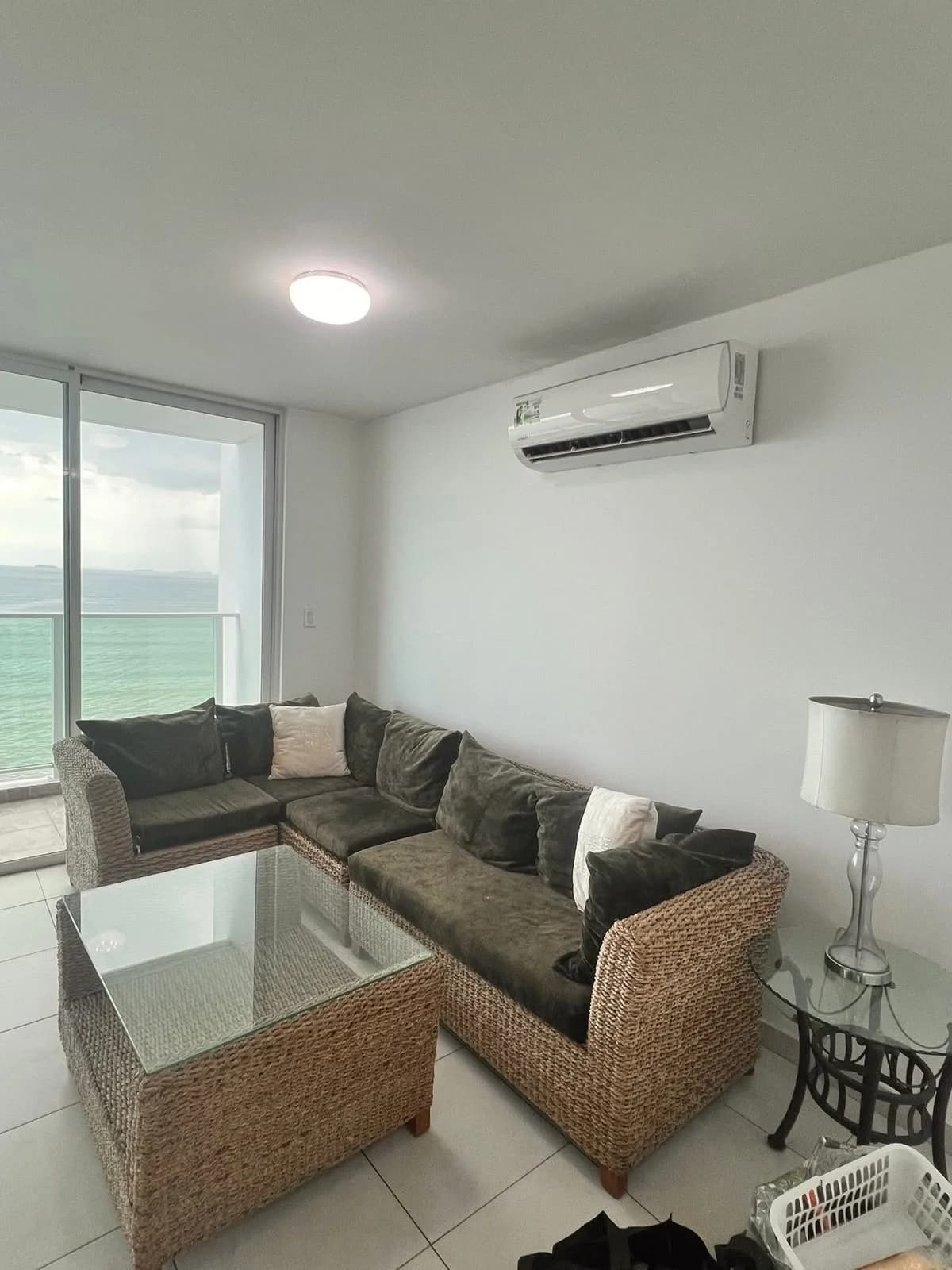 Living room of a Terramar apartment with sliding doors to the ocean-view balcony