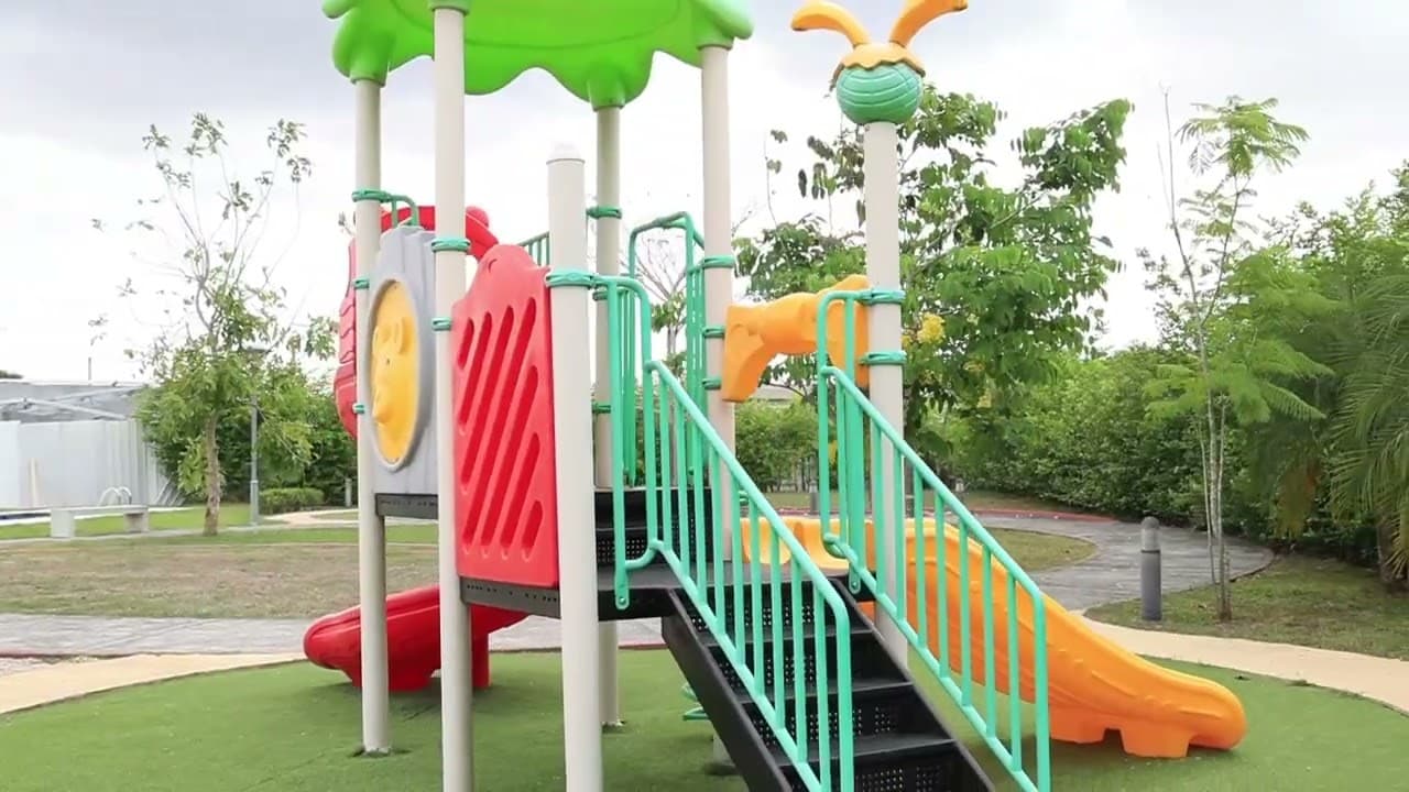 Children playground with slides on the lawn at Villasur Residences, Costa Sur