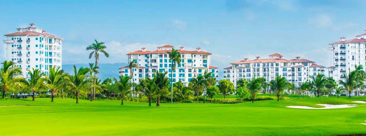 The Reserve residential towers rising above palms and the Santa Maria golf course fairway