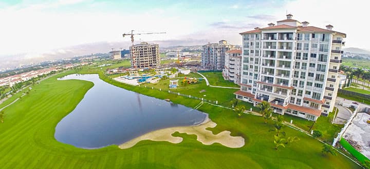 Aerial view of The Reserve tower beside the lake and golf course at Santa Maria