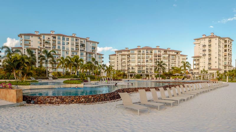 The Reserve beach-entry pool with loungers in front of the residential towers