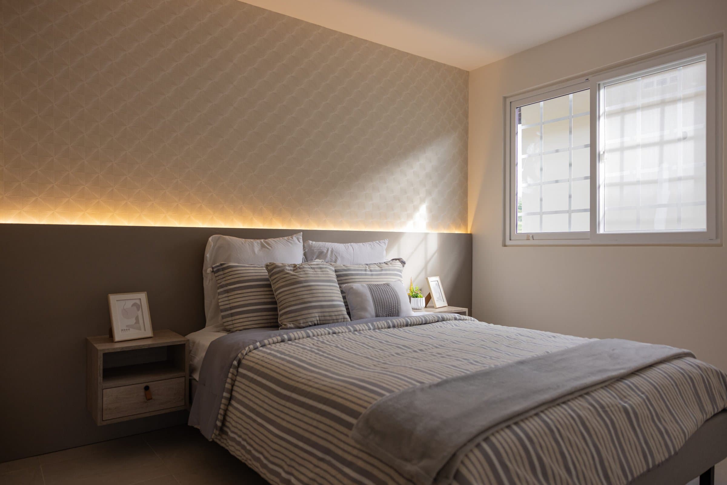 Main bedroom with backlit headboard wall in the Colonia Real model house