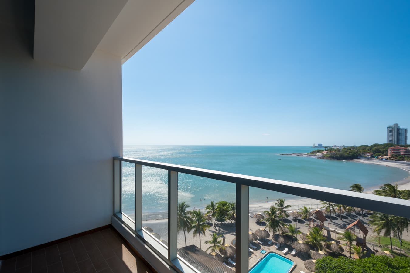 Balcony view over the beach and pool from a Royal Palm apartment