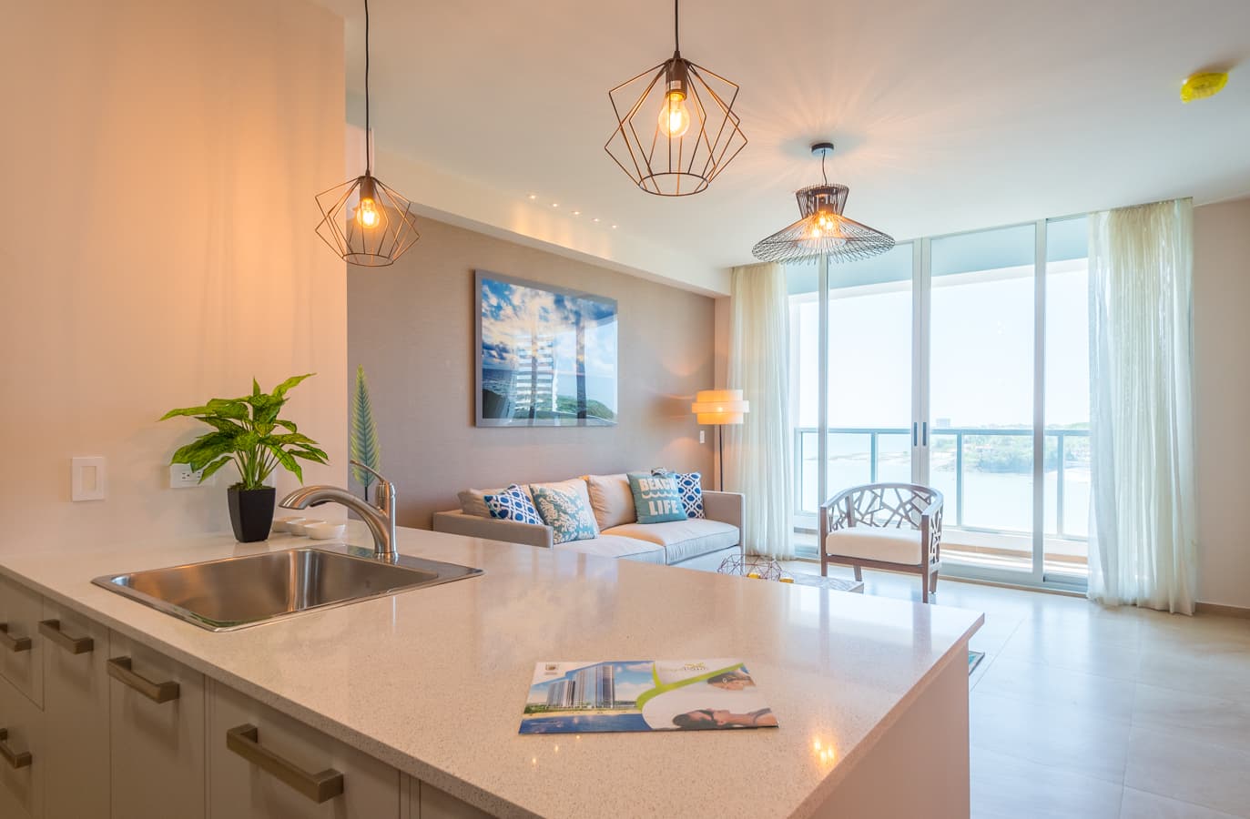 Kitchen and living room with ocean-view windows in a Royal Palm apartment