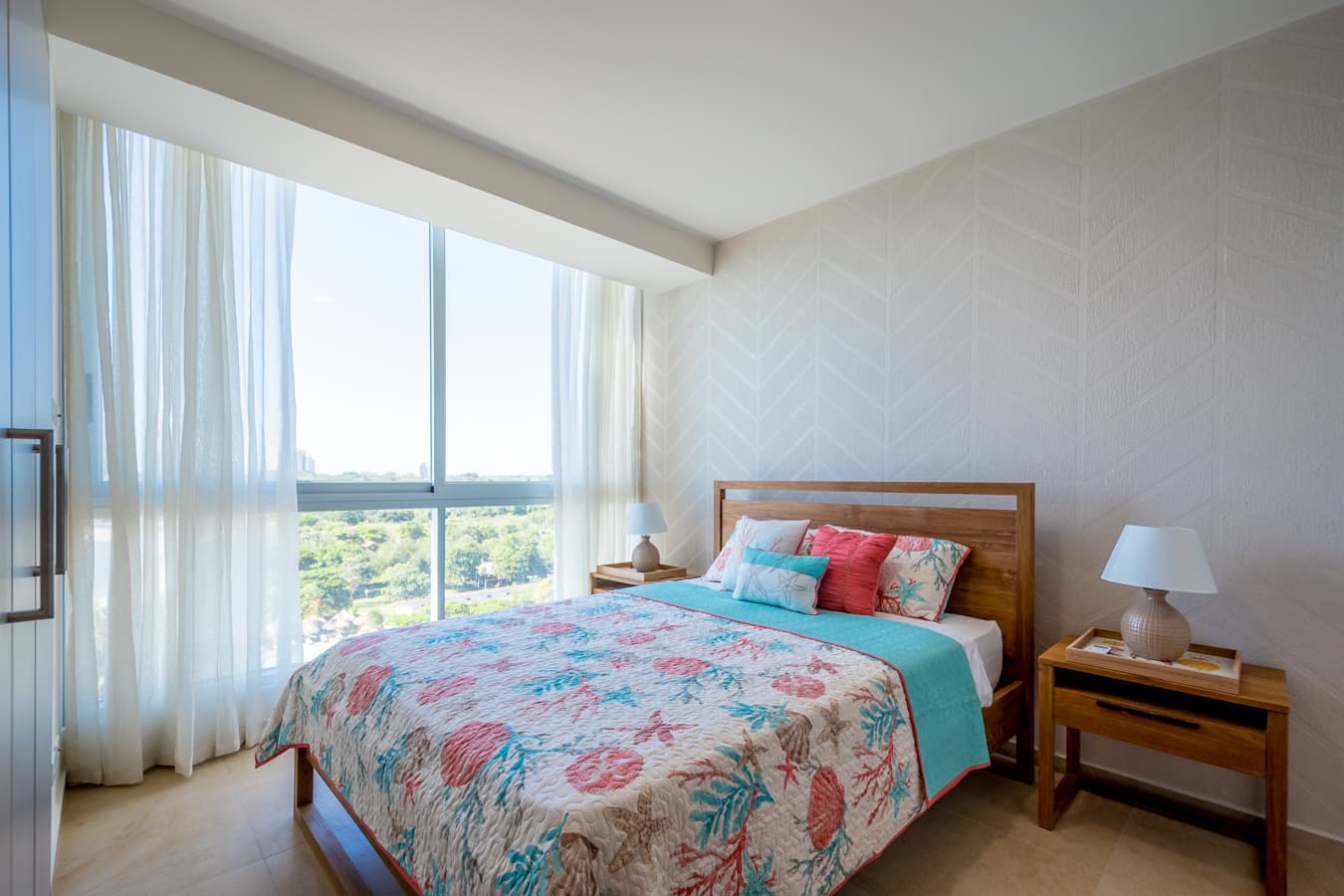 Bedroom with floor-to-ceiling window in a Royal Palm apartment
