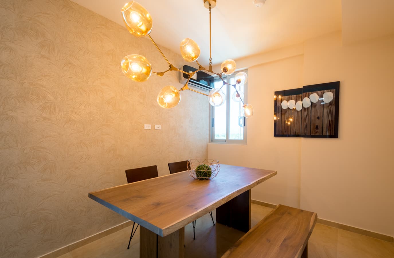 Dining room with pendant chandelier in a Royal Palm apartment
