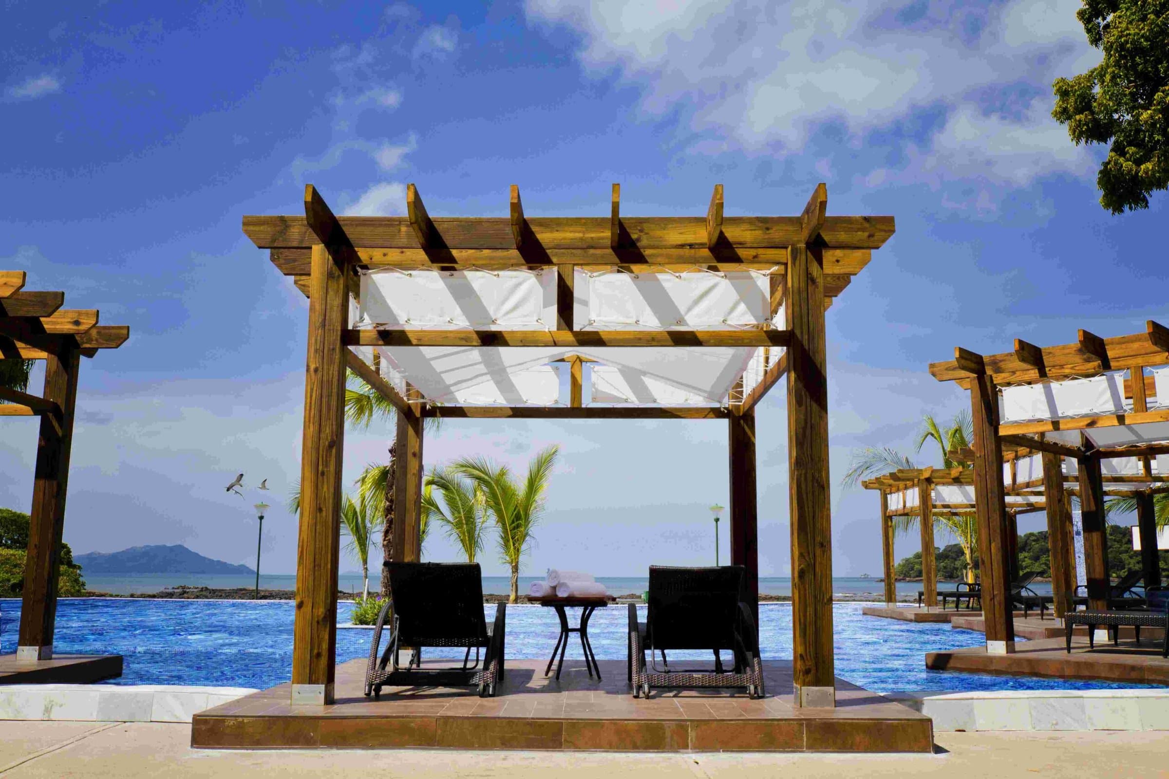 Oceanfront pergolas with loungers at The Pearl Club, Casa Bonita