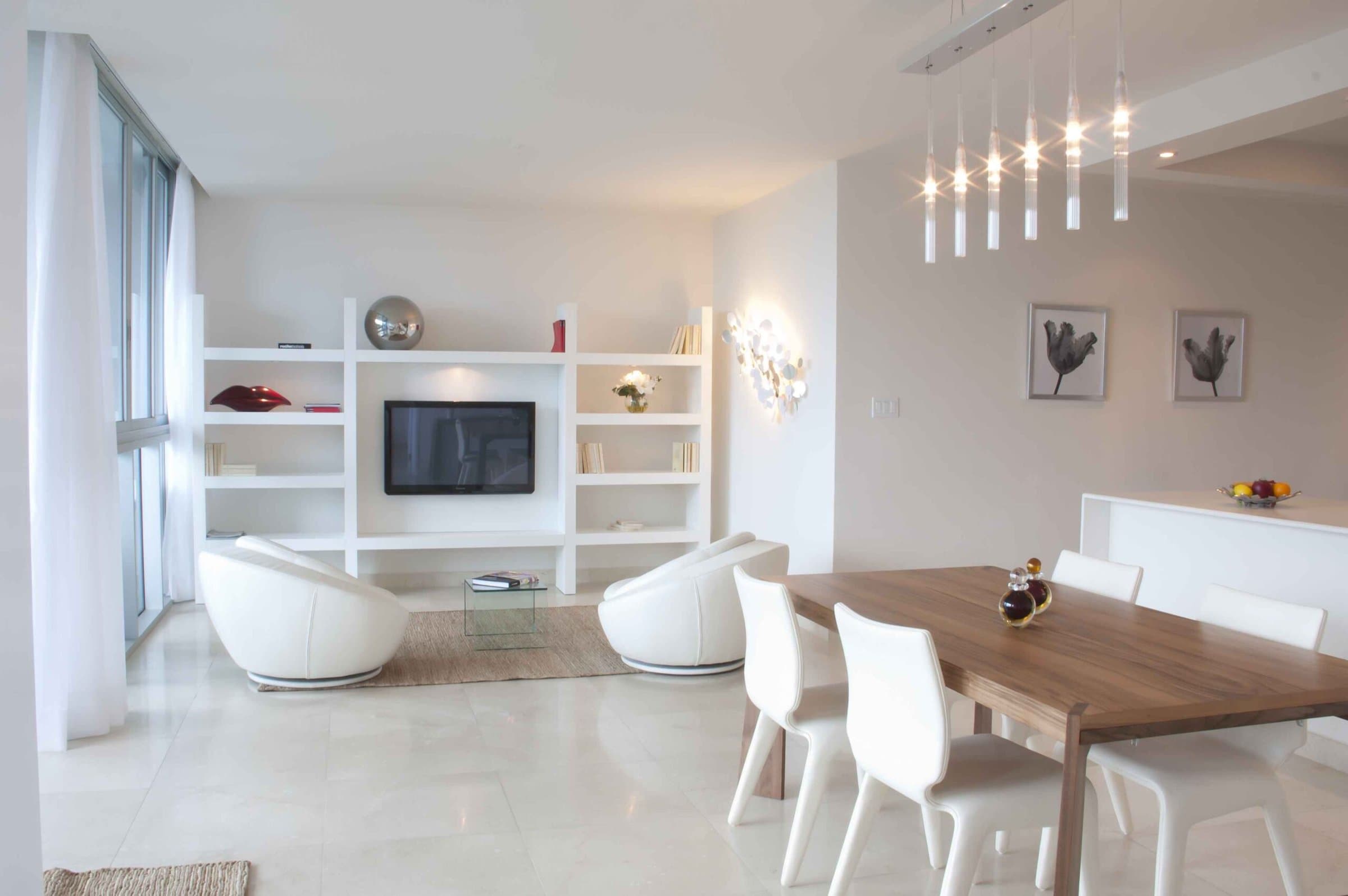 Bright white living and dining area in a Casa Bonita apartment