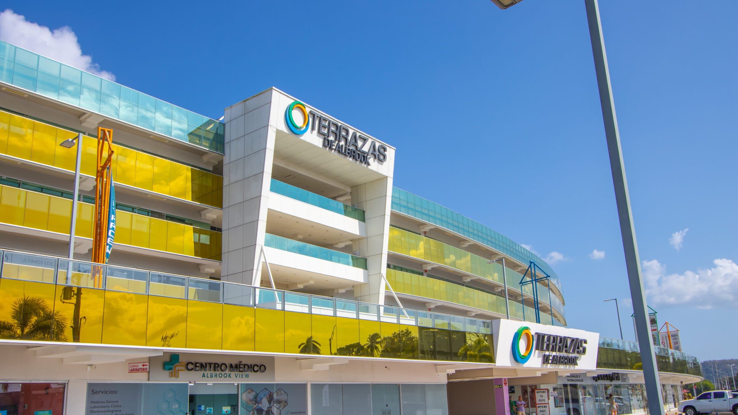 Terrazas de Albrook facade with yellow glass railings and signage