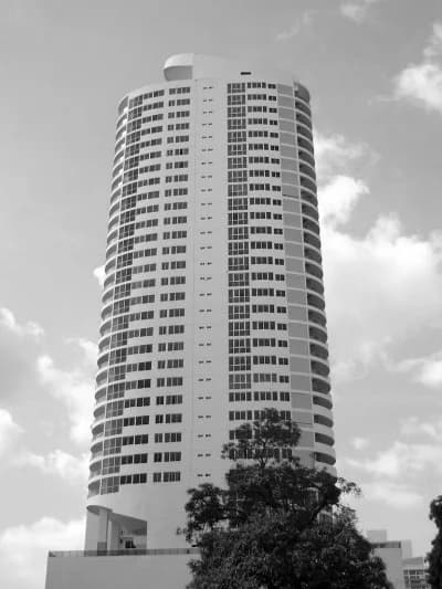 Black-and-white view of the rounded PH Joy Tower residential high-rise, San Francisco, Panama City